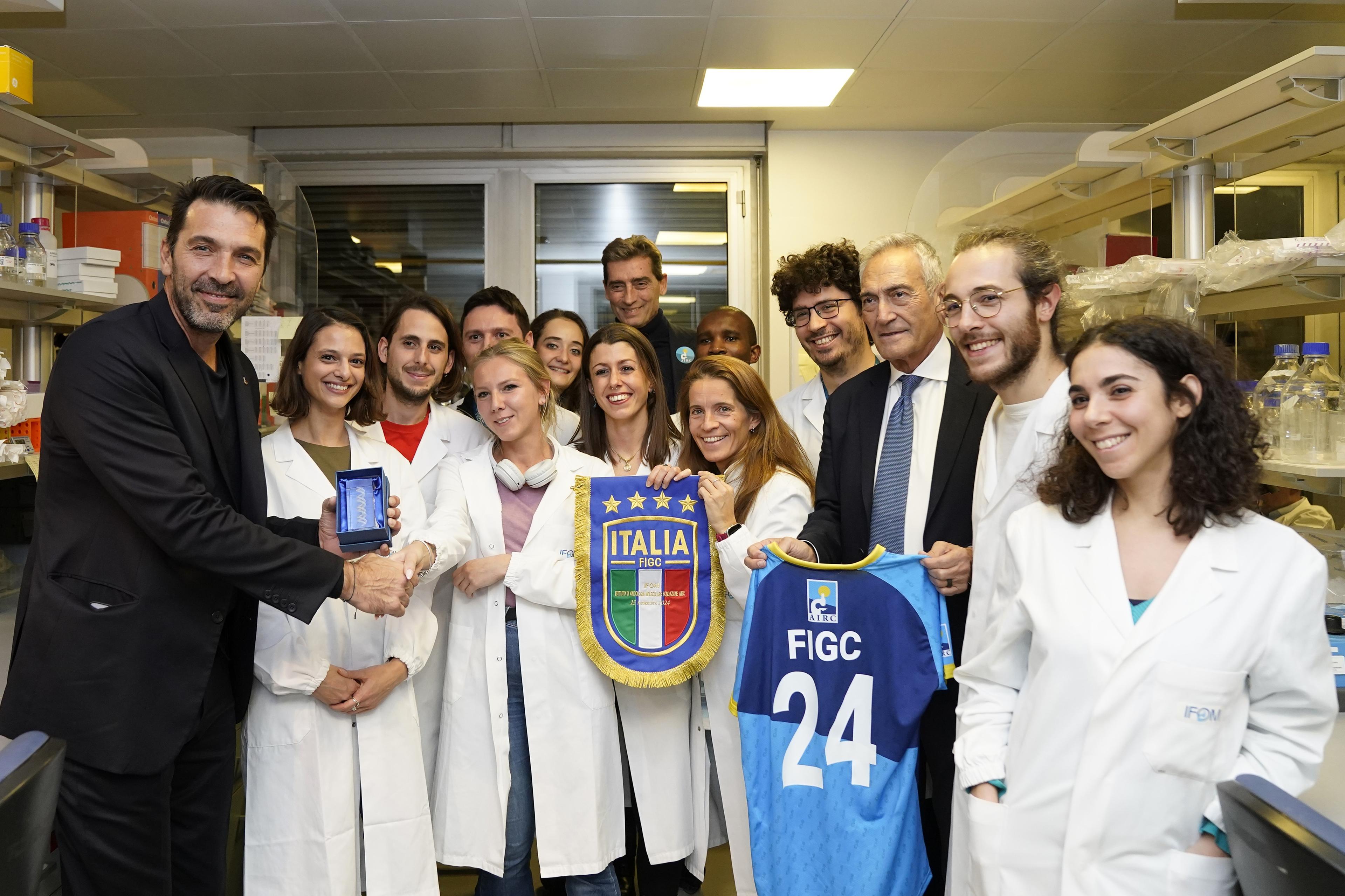 MILAN, ITALY - NOVEMBER 15: Andrea Sironi President AIRC, Gabriele Gravina President of FIGC and Gianluigi Buffon of FIGC pose for a photo during the visit of FIGC delegation at the IFOM Cancer Reseatch Institute on November 15, 2024 in Milan, Italy. (Photo by FIGC/FIGC via Getty Images)