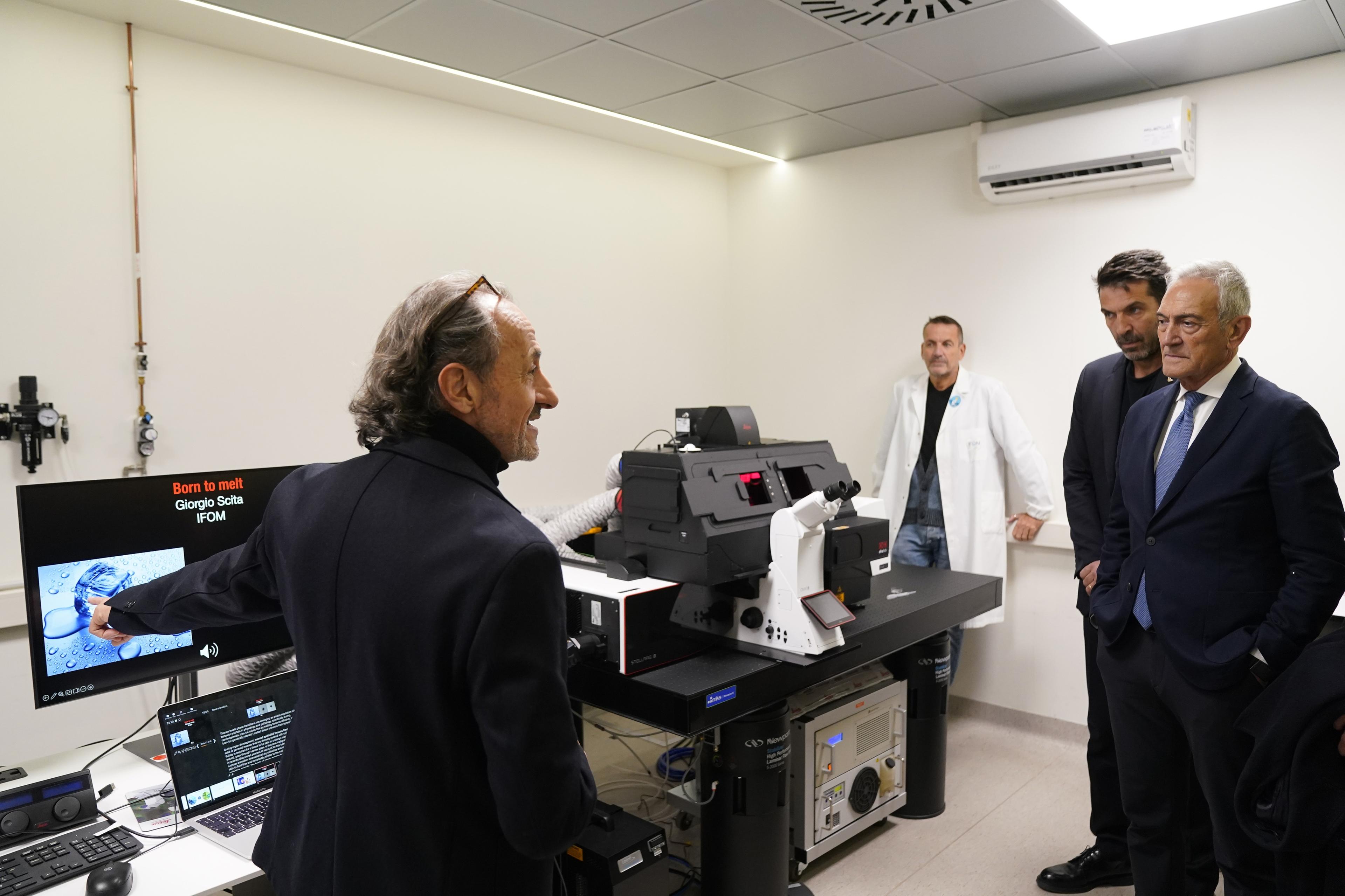 MILAN, ITALY - NOVEMBER 15: Gianluigi Buffon of FIGC and Gabriele Gravina President of FIGC attend a visit of FIGC delegation at the IFOM Cancer Reseatch Institute on November 15, 2024 in Milan, Italy. (Photo by FIGC/FIGC via Getty Images)