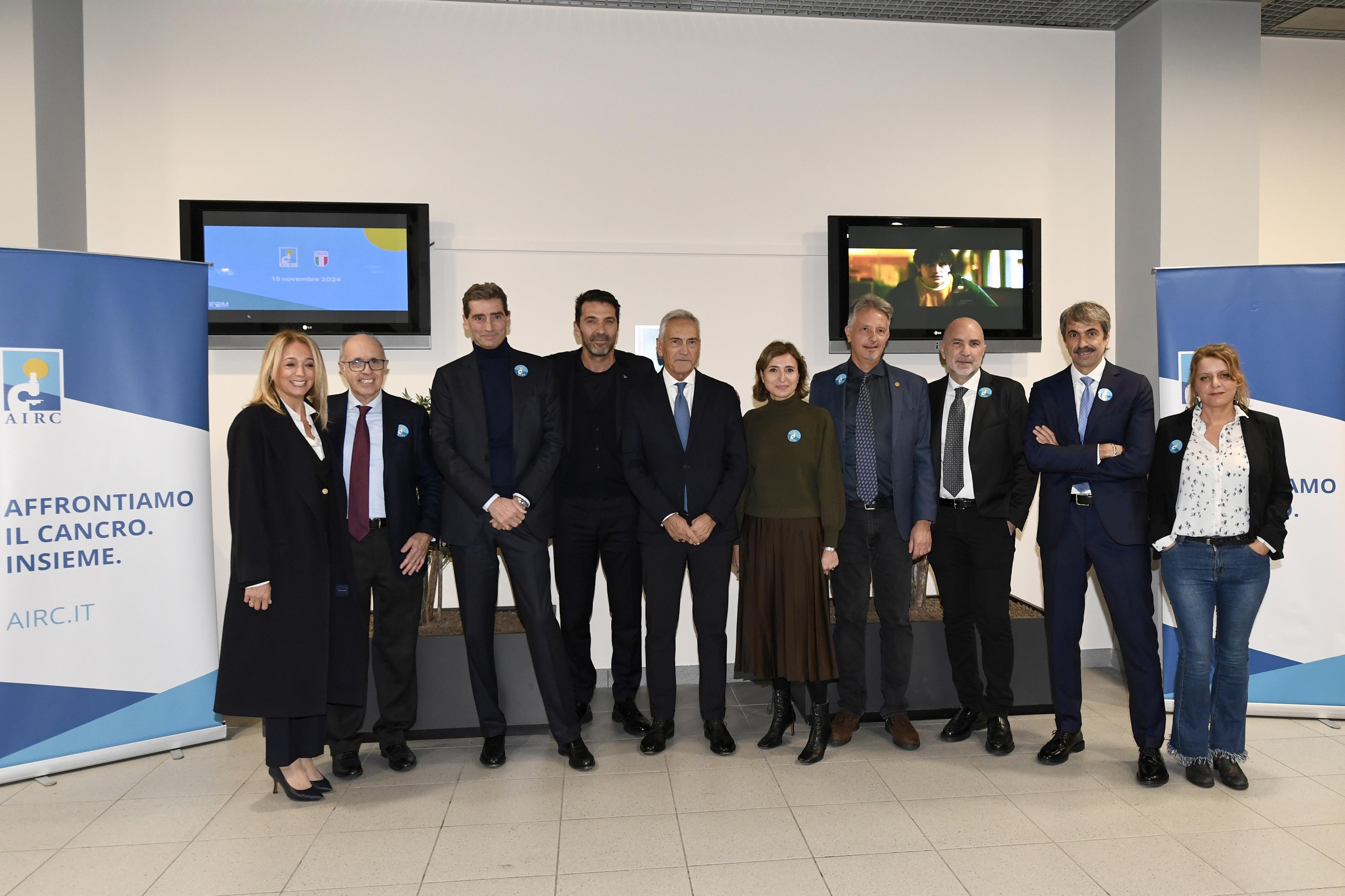 MILAN, ITALY - NOVEMBER 15: (L-R) Benedetta Geronzi, Giovanni Azzone President IFOM, Andrea Sironi President of AIRC Gianluigi Buffon of FIGC, Gabriele Gravina President of FIGC, Chiara Occulti, Alberto Bardelli. pose for a photo during the visit of FIGC delegation at the IFOM Cancer Reseatch Institute on November 15, 2024 in Milan, Italy. (Photo by FIGC/FIGC via Getty Images)