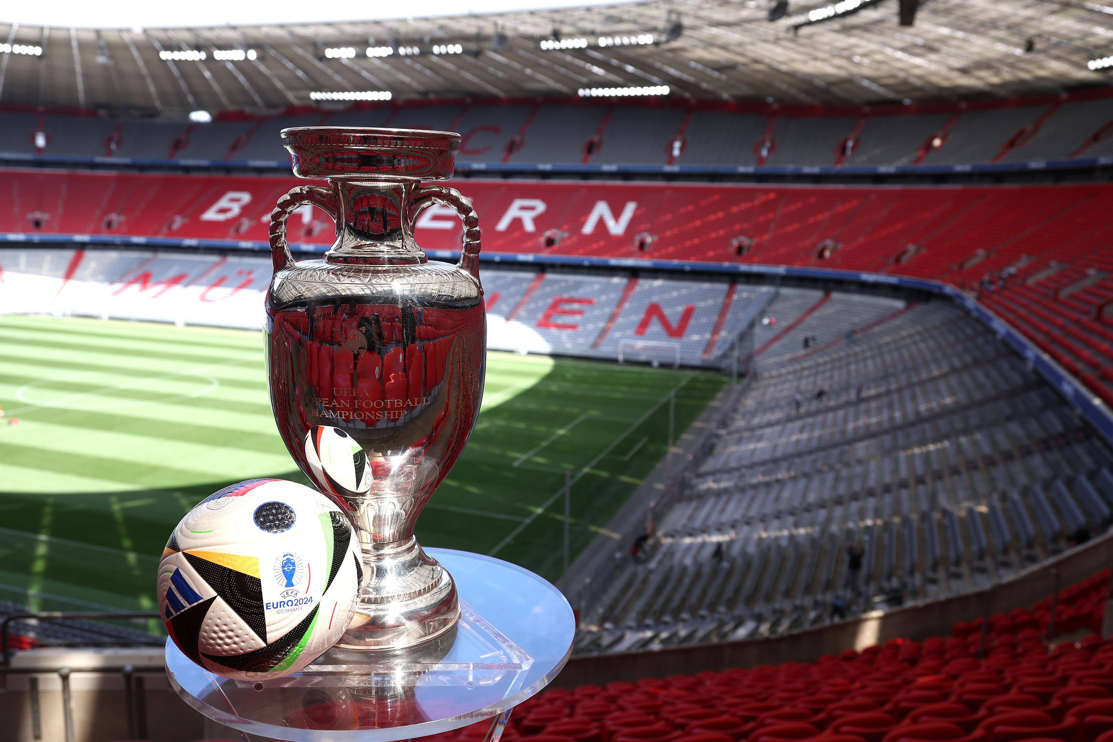 MUNICH, GERMANY - MAY 13: The UEFA EURO 2024 Winners Trophy is pictured with the official adidas matchball Fu\\u00C3\\u0178ballliebe in the Allianz Arena during the UEFA Euro 2024 Trophy Tour on May 13, 2024 in Munich, Germany. (Photo by Alexander Hassenstein - UEFA/UEFA via Getty Images)