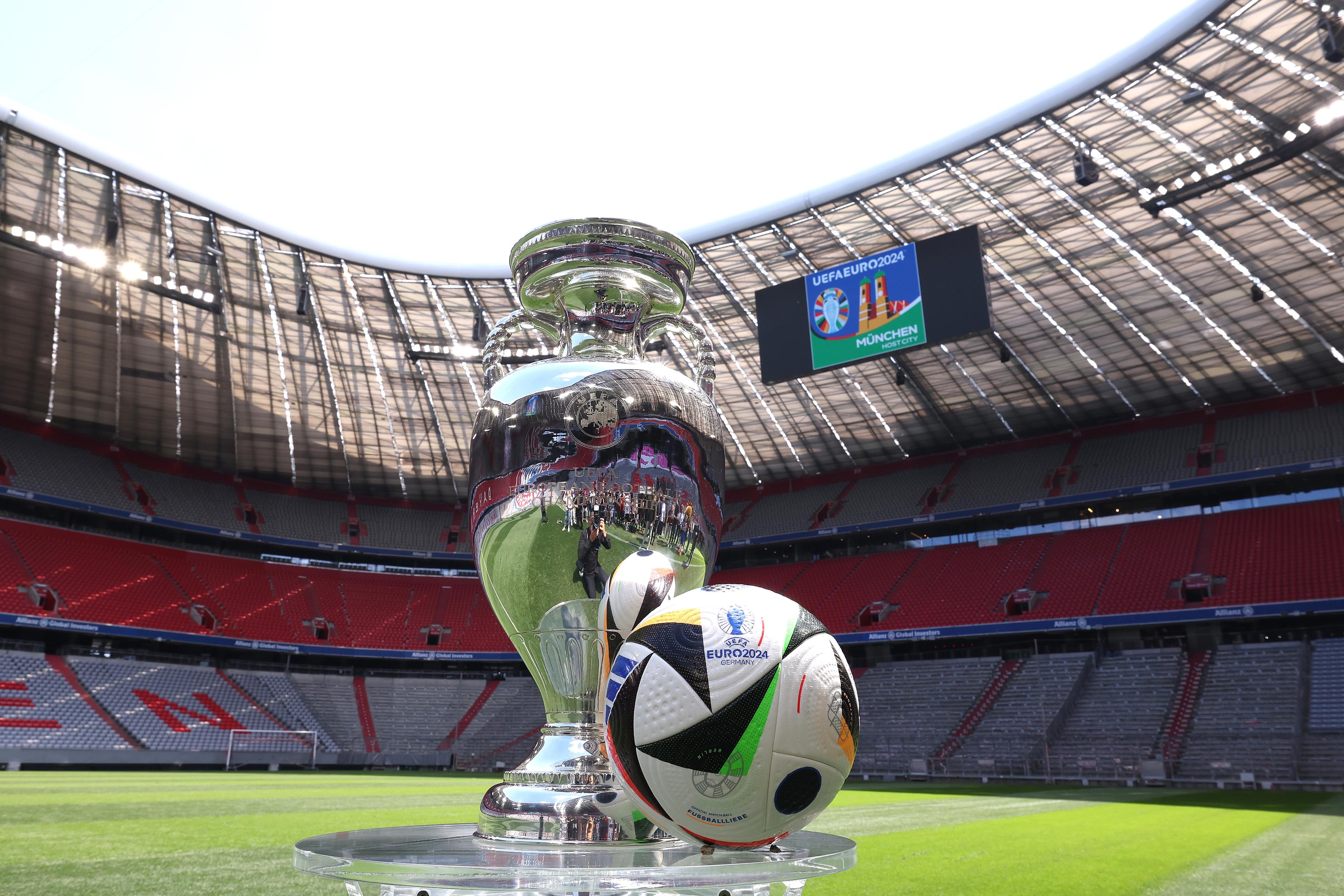 MUNICH, GERMANY - MAY 13: The UEFA EURO 2024 Winners Trophy is pictured with the official adidas matchball Fu\\u00C3\\u0178ballliebe in the Allianz Arena during the UEFA Euro 2024 Trophy Tour on May 13, 2024 in Munich, Germany. (Photo by Alexander Hassenstein - UEFA/UEFA via Getty Images)