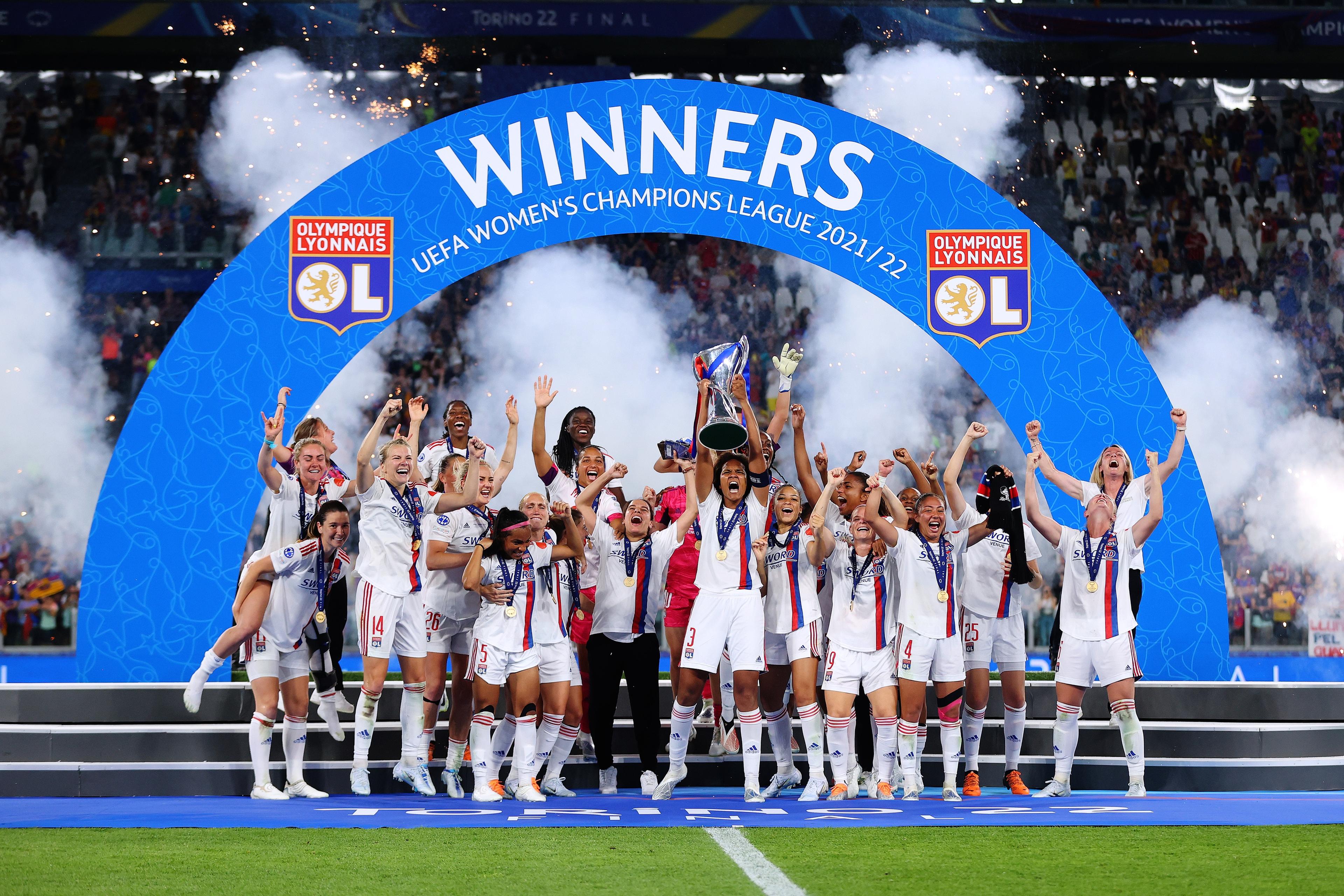 TURIN, ITALY - MAY 21: Wendie Renard of Olympique Lyonnais lifts the UEFA Women\\'s Champions League trophy after their sides victory during the UEFA Women\\'s Champions League final match between FC Barcelona and Olympique Lyonnais at Juventus Stadium on May 21, 2022 in Turin, Italy. (Photo by Catherine Ivill - UEFA/UEFA via Getty Images)