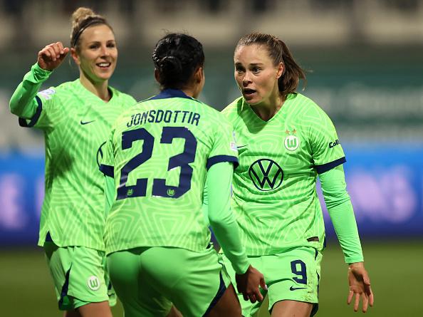 WOLFSBURG, GERMANY - DECEMBER 08: Ewa Pajor of Wolfsburg celebrates with team mates after scoring the opening goal of the game during the UEFA Women's Champions League group B match between VfL Wolfsburg and AS Roma at AOK-Stadion on December 08, 2022 in Wolfsburg, Germany. (Photo by Martin Rose/Getty Images)