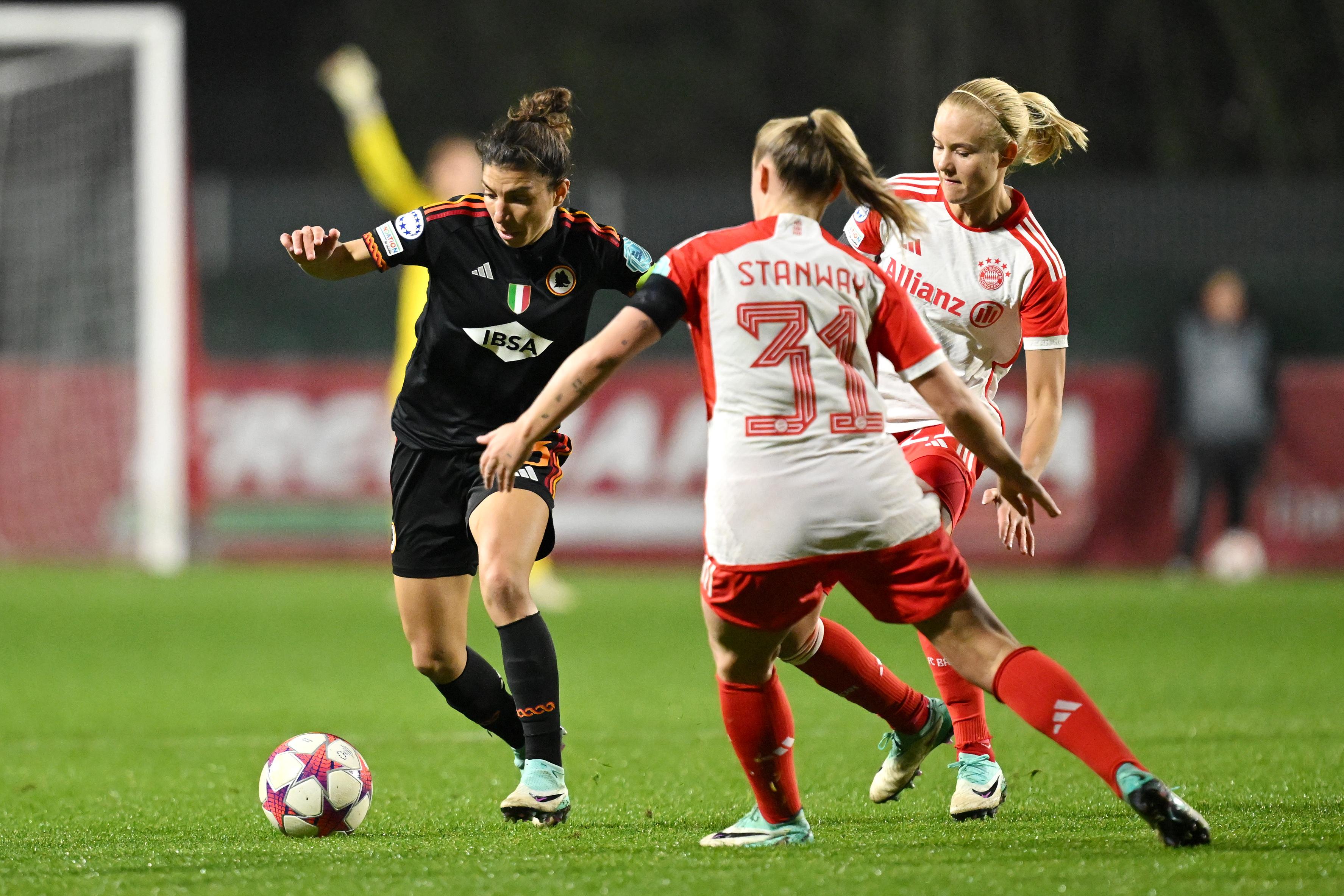 ROME, ITALY - JANUARY 24: Elisa Bartoli of AS Roma runs with the ball whilst under pressure from Georgia Stanway of Bayern Munich during the UEFA Women\\'s Champions League group stage match between AS Roma and FC Bayern M\\u00C3\\u00BCnchen at Stadio Tre Fontane on January 24, 2024 in Rome, Italy. (Photo by Tullio Puglia - UEFA/UEFA via Getty Images)