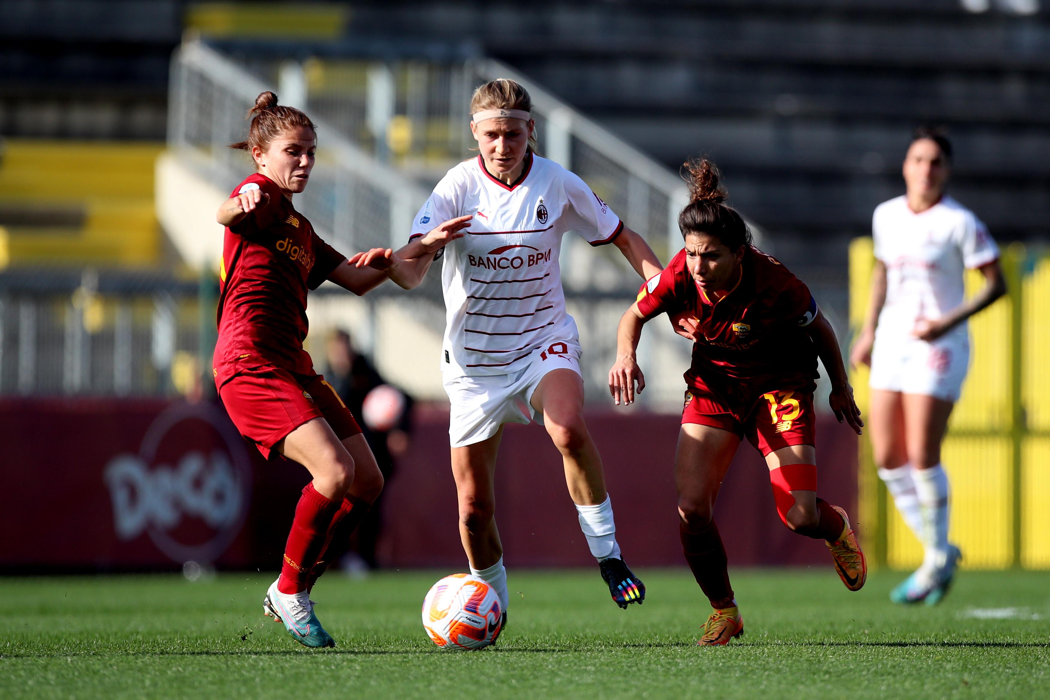ROME, ITALY - MARCH 11: Manuela Giuliano and Elisa Bartoli of AS Roma compete for the ball with Kamila Dubkova of AC Milan during the Women Coppa Italia semifinal second leg match between AS Roma and AC Milan at Stadio Tre Fontane on March 11, 2023 in Rome, Italy. (Photo by Paolo Bruno/Getty Images)