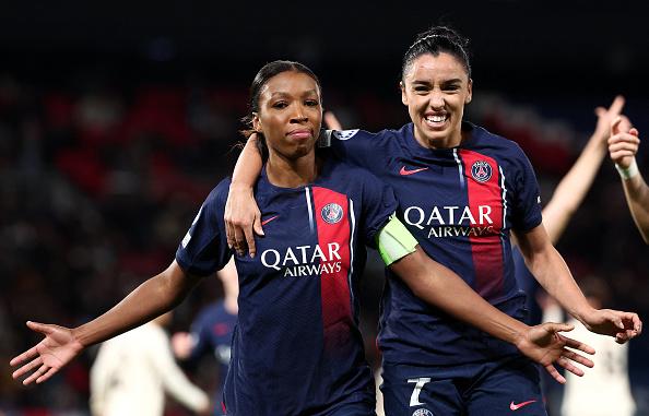 TOPSHOT - Paris Saint Germain's Congolese midfielder #08 Grace Geyoro (L) celebrates with teammates Paris Saint Germain's French defender #07 Sakina Karchaoui (R) after scoring her team's first goal during the UEFA Women's Champions League Group C football match between Paris Saint-Germain (PSG) and AS Roma at the Parc des Princes stadium in Paris, on December 14, 2023. (Photo by FRANCK FIFE / AFP) (Photo by FRANCK FIFE/AFP via Getty Images)