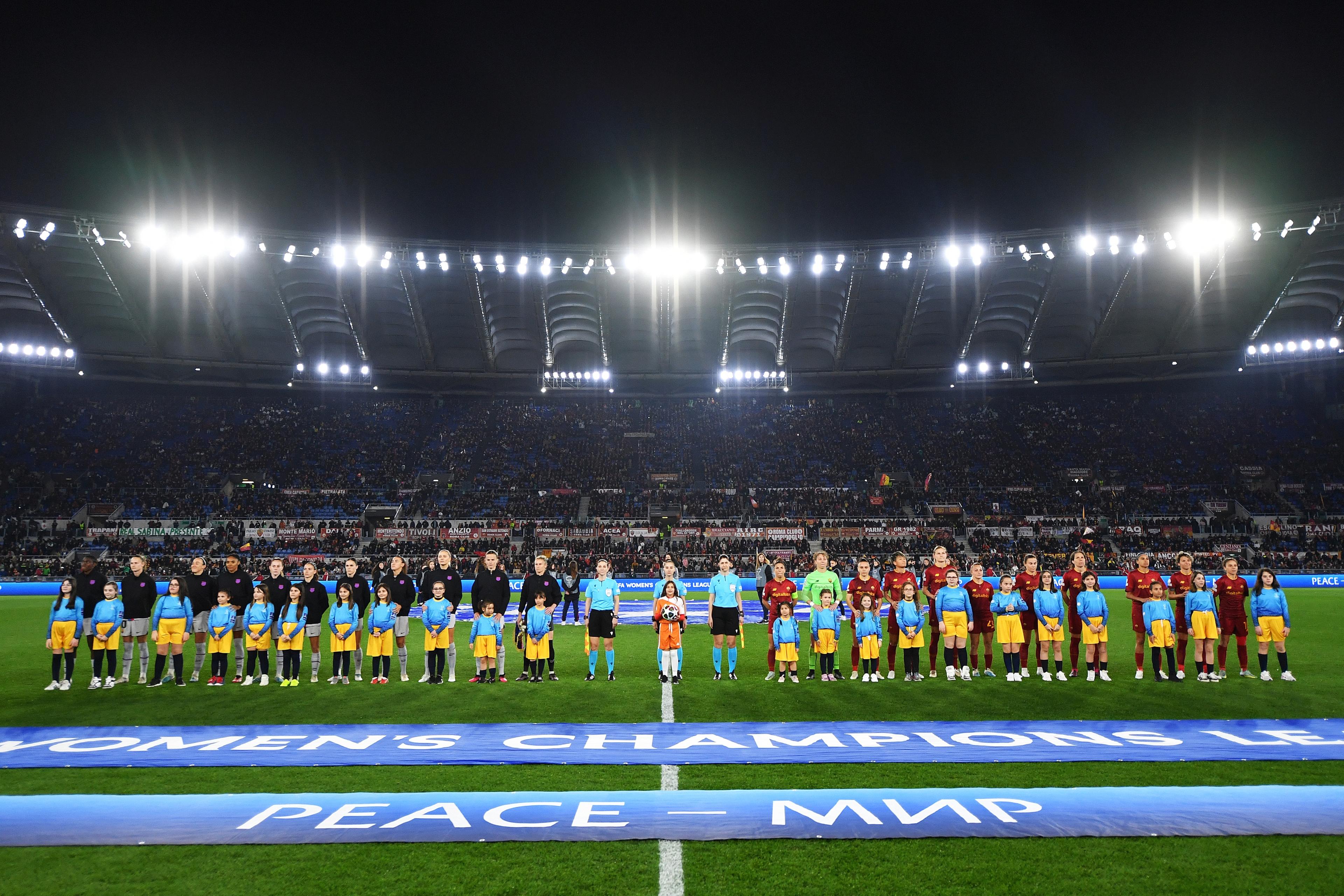 ROME, ITALY - MARCH 21: Players of both teams line up on pitch prior to the UEFA Women\\'s Champions League quarter-final 1st leg match between AS Roma and FC Barcelona at Stadio Tre Fontane on March 21, 2023 in Rome, Italy. (Photo by Valerio Pennicino - UEFA/UEFA via Getty Images)