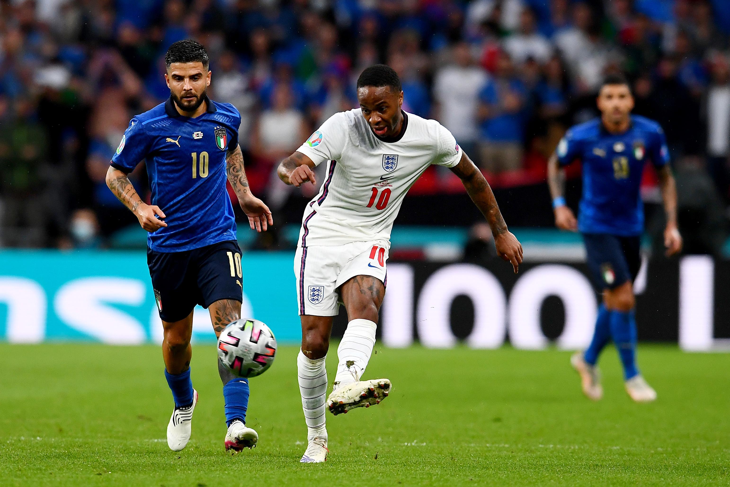 LONDON, ENGLAND - JULY 11: Raheem Sterling of England makes a pass whilst under pressure from Lorenzo Insigne of Italy during the UEFA Euro 2020 Championship Final between Italy and England at Wembley Stadium on July 11, 2021 in London, England. (Photo by Claudio Villa/Getty Images)