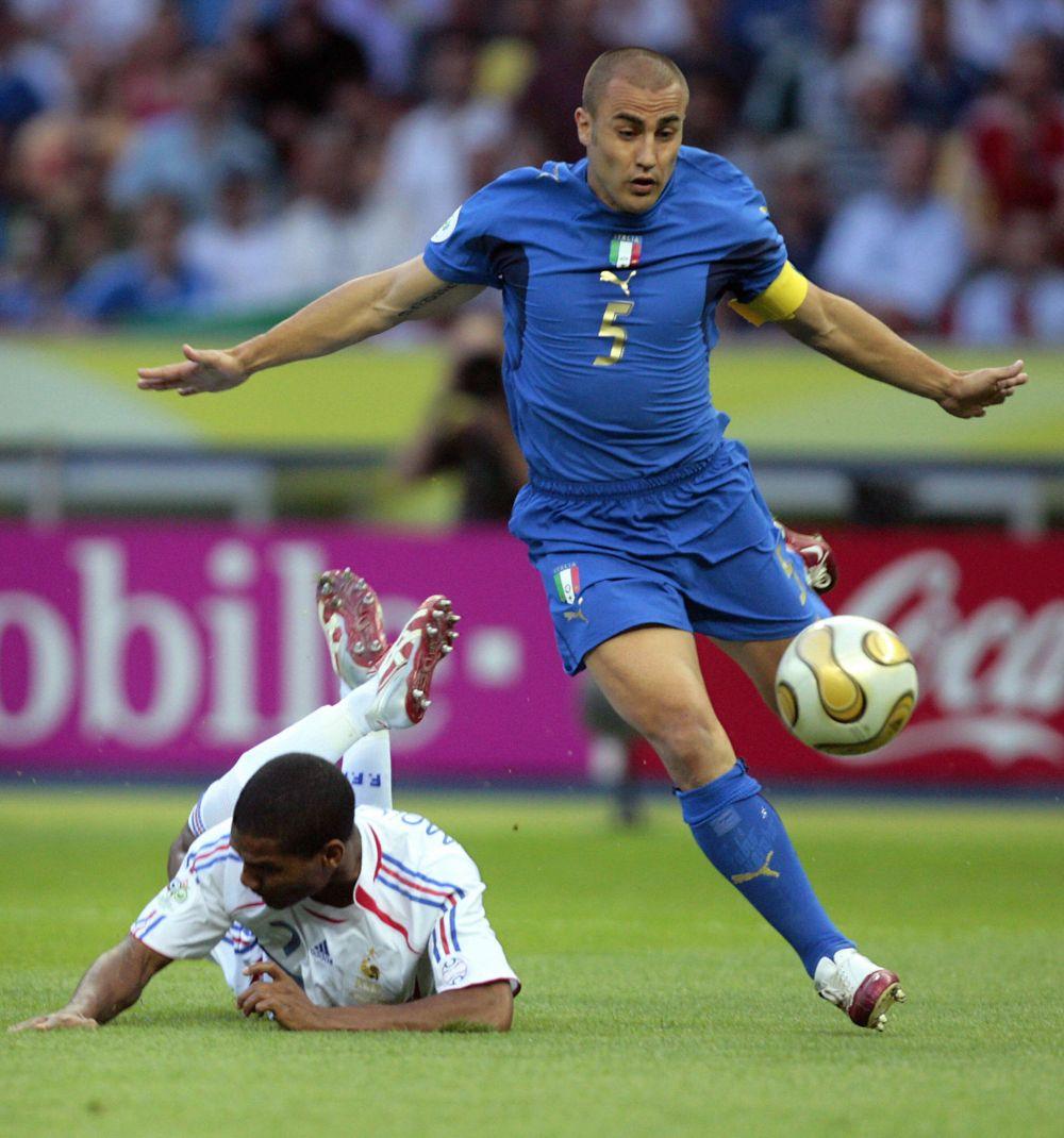 Berlin, GERMANY: French midfielder Florent Malouda(L) falls next to Italian defender Fabio Cannavaro during the World Cup 2006 final football game Italy vs.France, 09 July 2006 at Berlin stadium. AFP PHOTO PASCAL PAVANI (Photo credit should read PASCAL PAVANI/AFP/Getty Images)