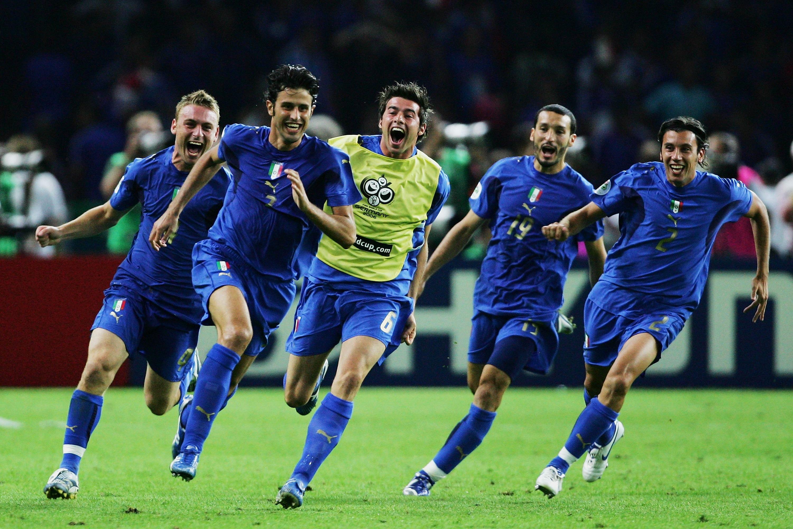 BERLIN - JULY 09:  Fabio Grosso of Italy celebrates victory with his team mates, after scoring the winning penalty in a penalty shootout at the end of the FIFA World Cup Germany 2006 Final match between Italy and France at the Olympic Stadium on July 9, 2006 in Berlin, Germany.  (Photo by Alex Livesey/Getty Images)