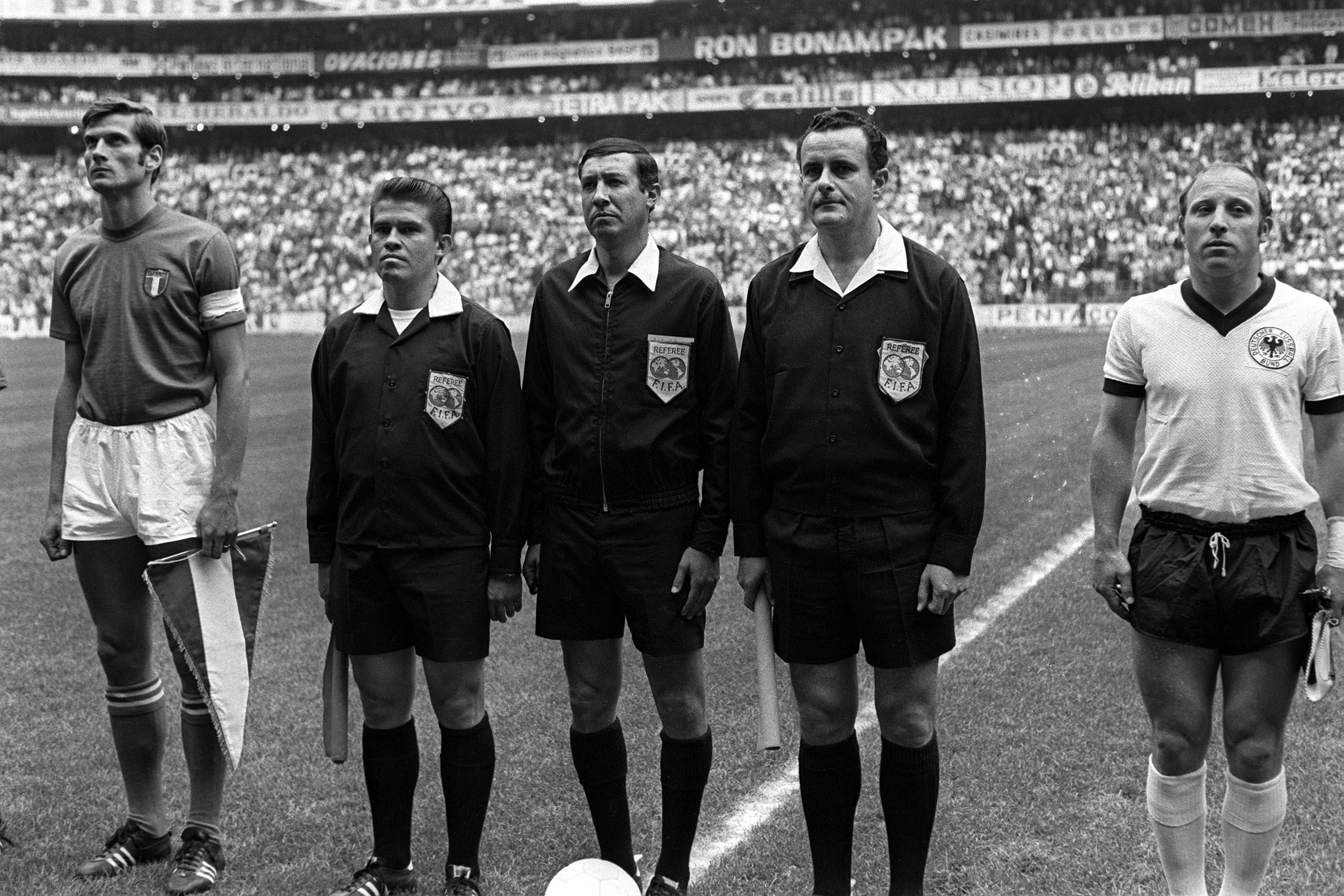 Sport, Football, 1970 World Cup Semi Final, Mexico City, Mexico, 17th June 1970, Italy 4 v West Germany 3, Italian captain Giacinto Facchetti (left) stands with West German captain Uwe Seeler (right) with the match officials before the match (Photo by Popperfoto via Getty Images/Getty Images)