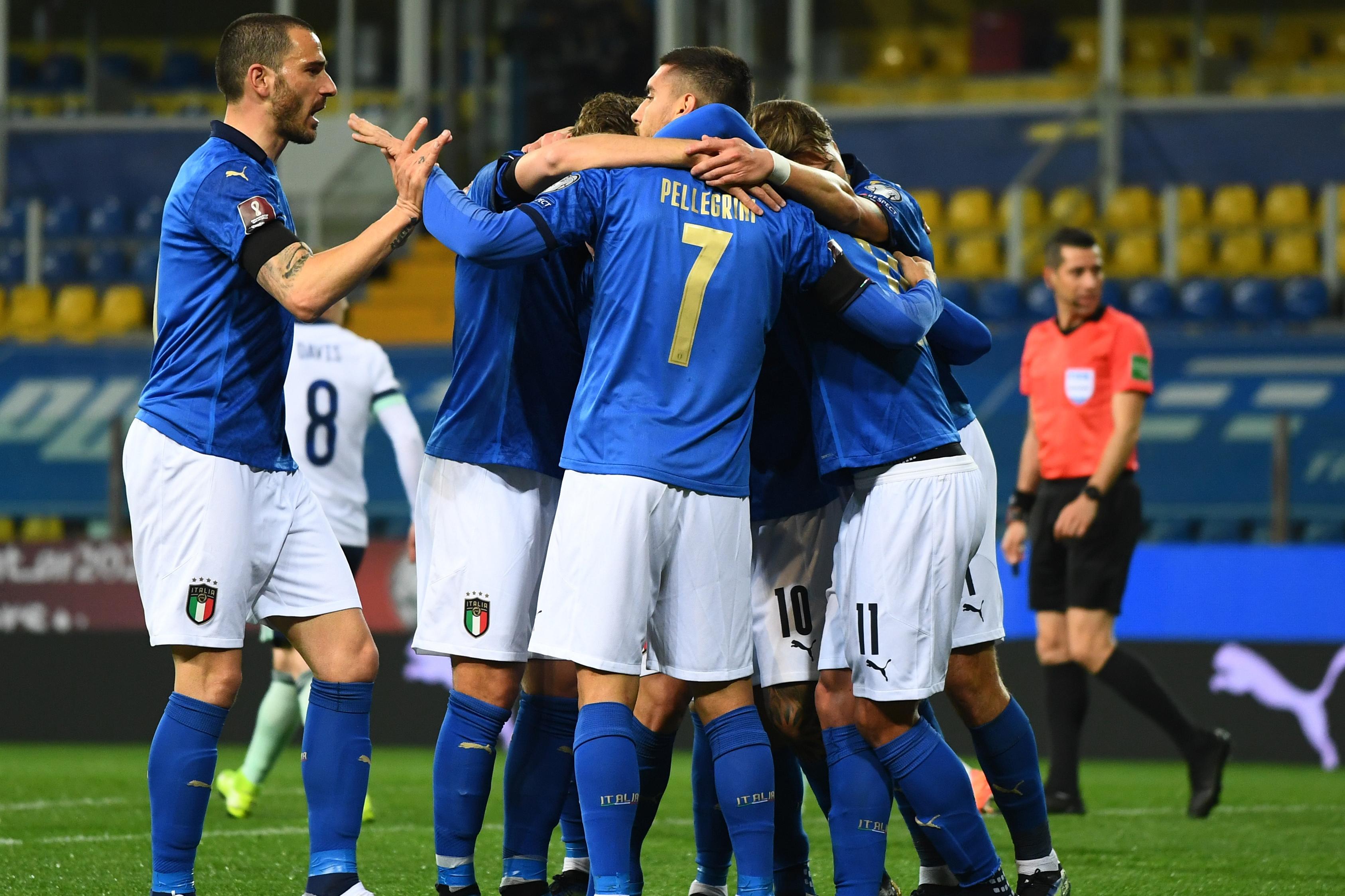 PARMA, ITALY - MARCH 25:  Domenico Berardi of Italy celebrates with team-mates after scoring the opening goal during the FIFA World Cup 2022 Qatar qualifying match between Italy and Northern Ireland on March 25, 2021 in Parma, Italy. Sporting stadiums around Italy remain under strict restrictions due to the Coronavirus Pandemic as Government social distancing laws prohibit fans inside venues resulting in games being played behind closed doors. (Photo by Claudio Villa/Getty Images)