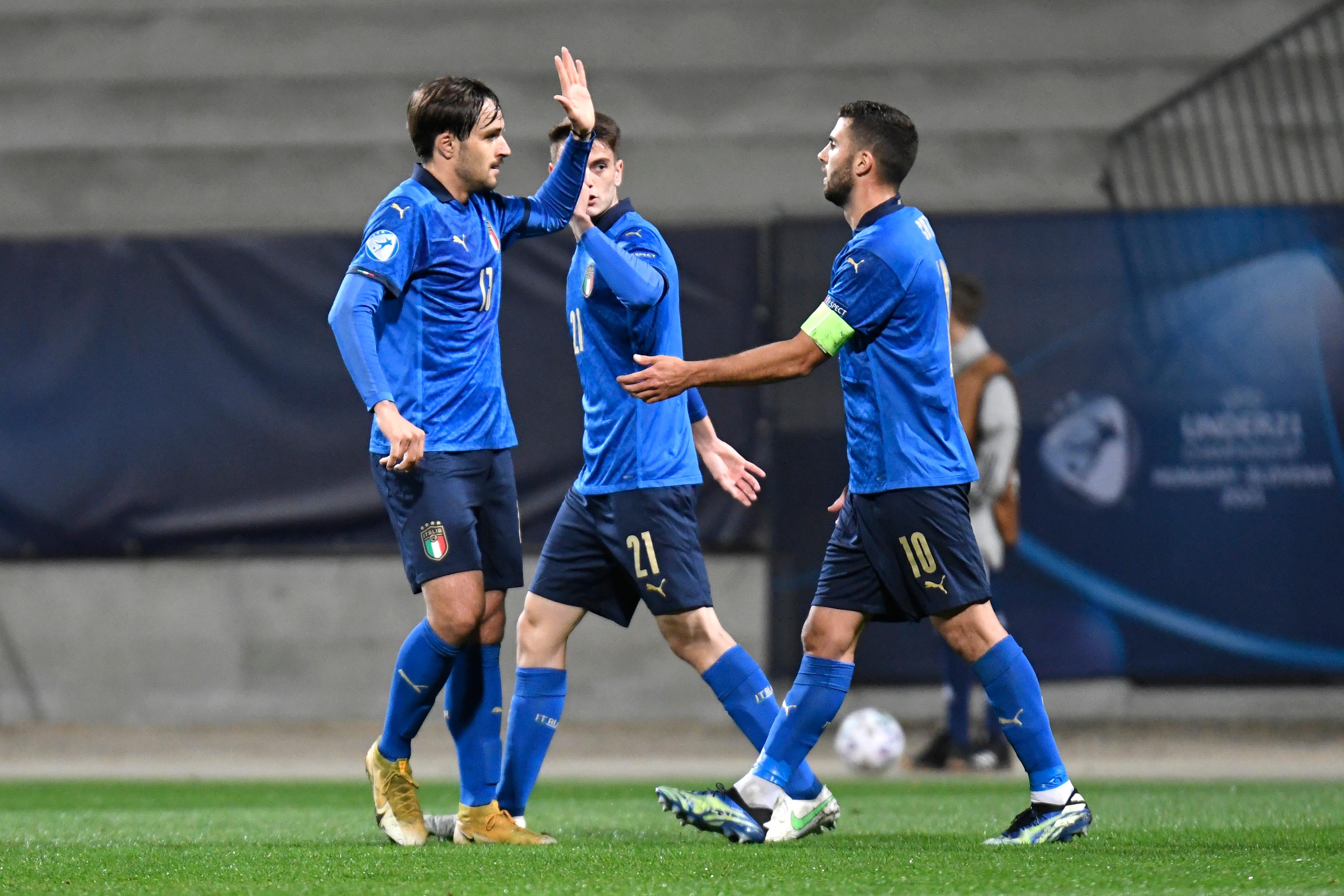 CELJE, SLOVENIA - MARCH 30: Gabriele Zappa and Patrick Cutrone of Italy celebrate after team mate Giacomo Raspadori (Not pictured) scored their side\\'s second goal during the 2021 UEFA European Under-21 Championship Group B match between Italy and Slovenia at Stadion Celje on March 30, 2021 in Celje, Slovenia. Sporting stadiums around Slovenia remain under strict restrictions due to the Coronavirus Pandemic as Government social distancing laws prohibit fans inside venues resulting in games being played behind closed doors. (Photo by Jurij Kodrun/Getty Images)