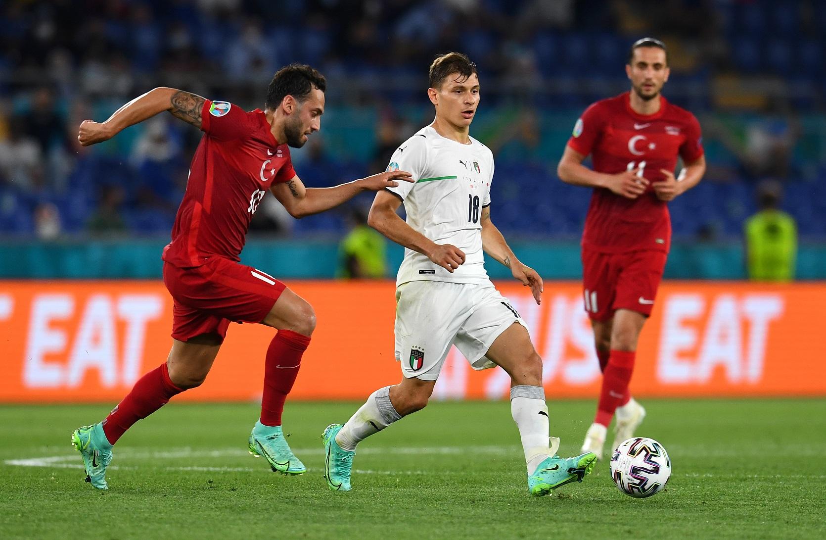 ROME, ITALY - JUNE 11: Nicolo Barella of Italy is closed down by Hakan Calhanoglu of Turkey during the UEFA Euro 2020 Championship Group A match between Turkey and Italy at the Stadio Olimpico on June 11, 2021 in Rome, Italy. (Photo by Claudio Villa/Getty Images)