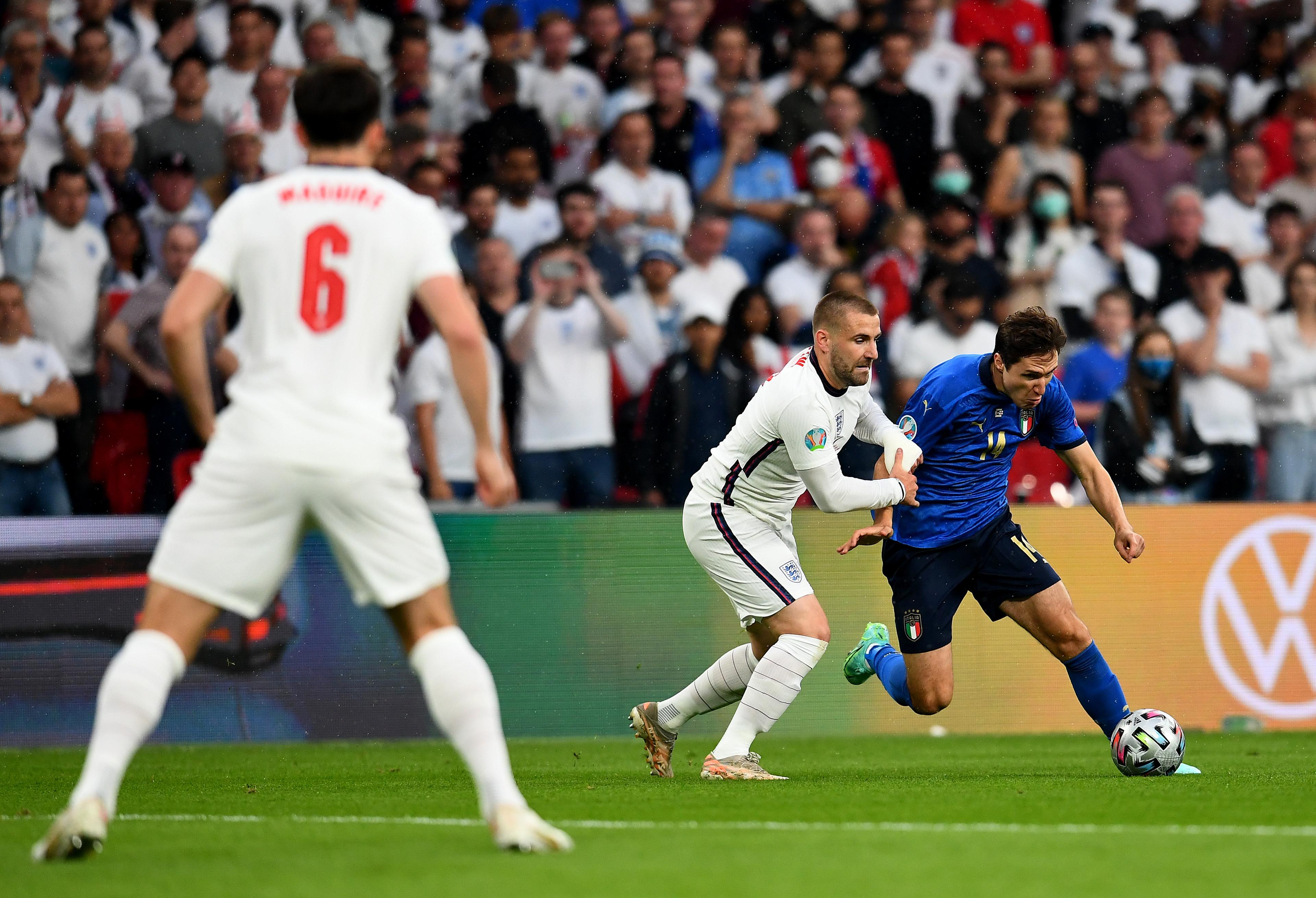 LONDON, ENGLAND - JULY 11: Federico Chiesa of Italy is challenged by Luke Shaw of England during the UEFA Euro 2020 Championship Final between Italy and England at Wembley Stadium on July 11, 2021 in London, England. (Photo by Claudio Villa/Getty Images)