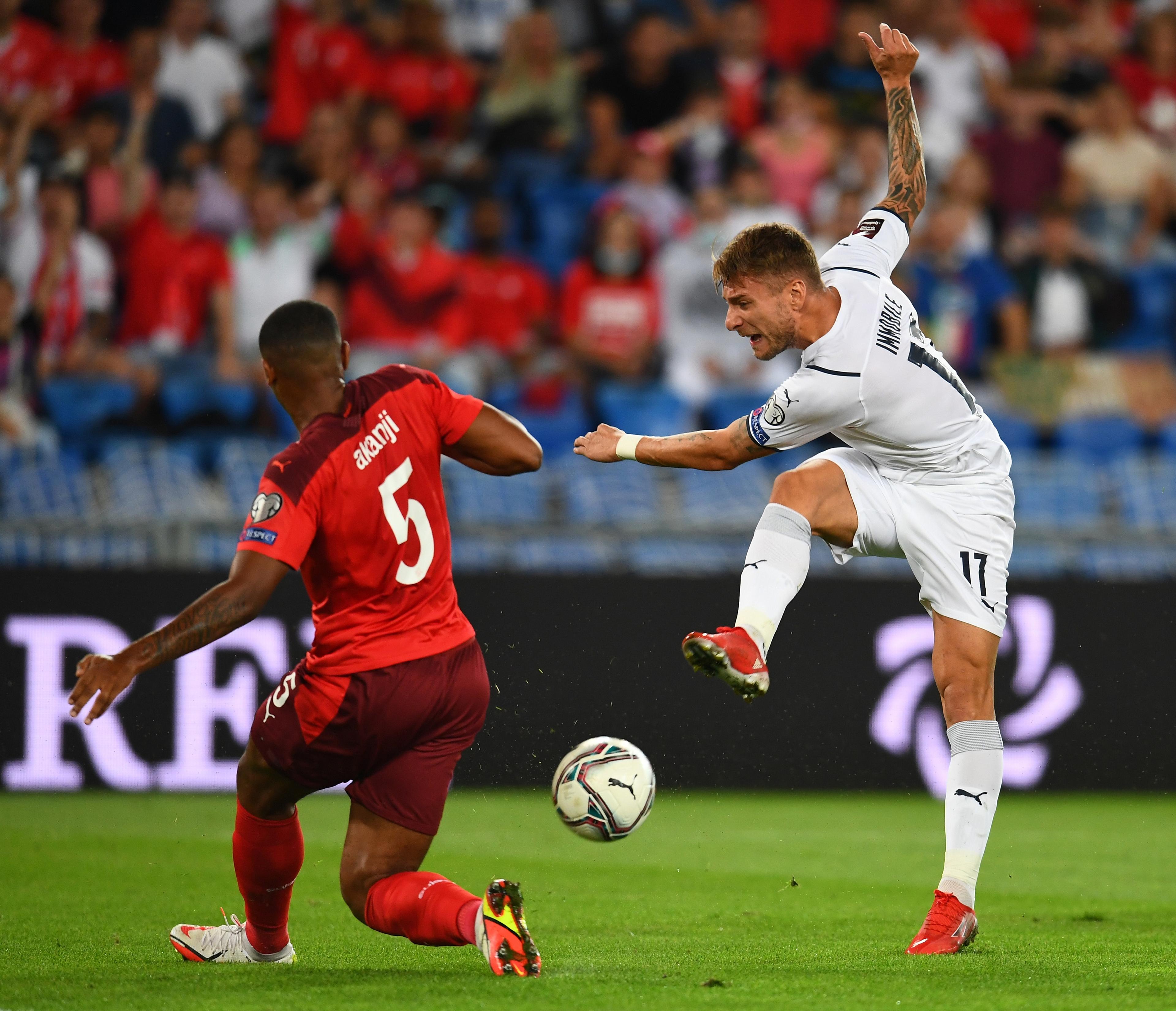 BASEL, SWITZERLAND - SEPTEMBER 05: Ciro Immobile of Italy competes for the ball with Mnuel Akanji of Switzerland during the 2022 FIFA World Cup Qualifier match between Switzerland and Italy at St Jacob Park on September 05, 2021 in Basel, Basel-Stadt. (Photo by Claudio Villa/Getty Images)