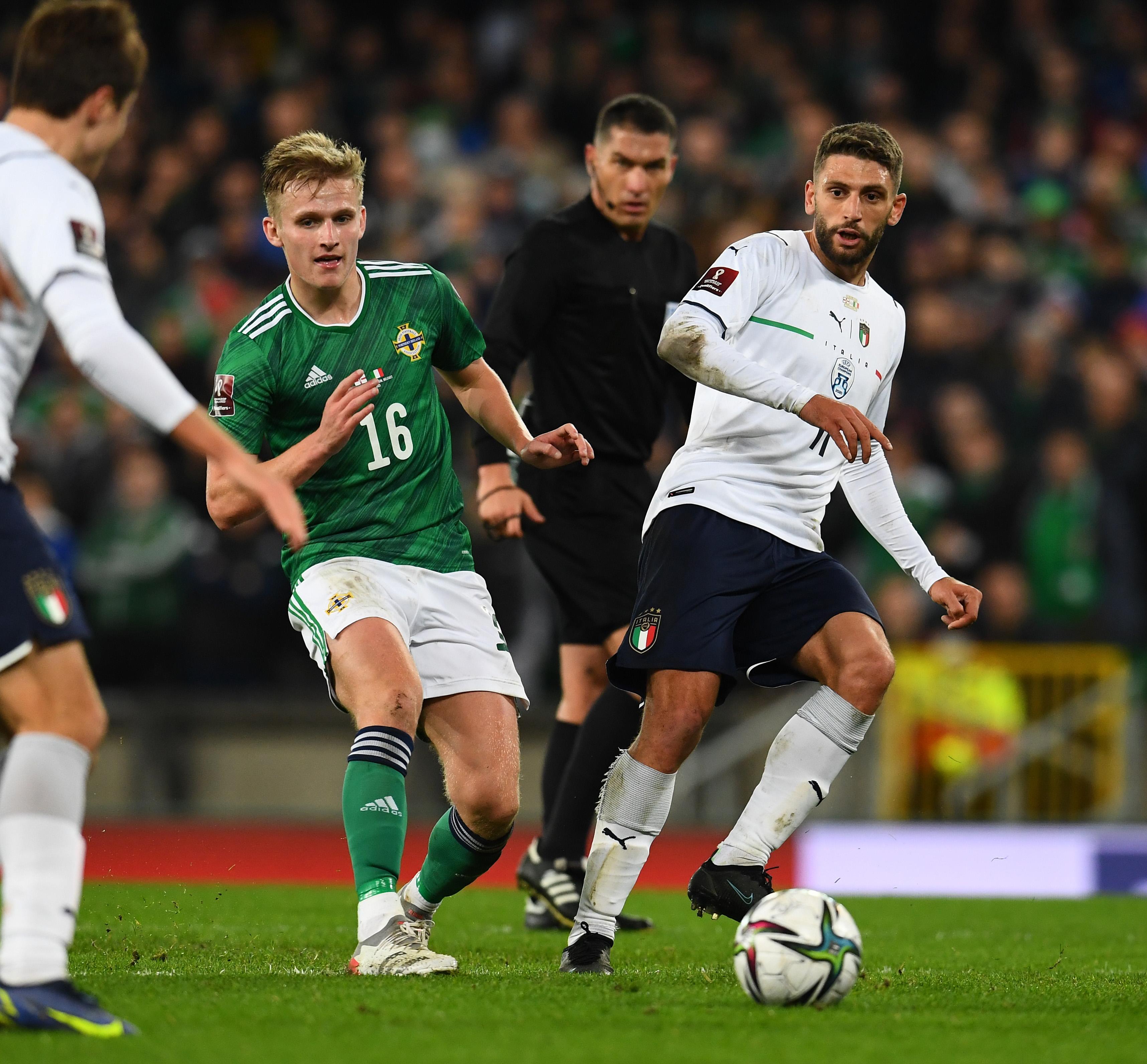 BELFAST, NORTHERN IRELAND - NOVEMBER 15: Domenico Berardi of Italy competes for the ball with Alistair McCann of Northem Ireland during the 2022 FIFA World Cup Qualifier match between Northern Ireland and Italy at Windsor Park on November 15, 2021 in Belfast, Northern Ireland. (Photo by Claudio Villa/Getty Images)