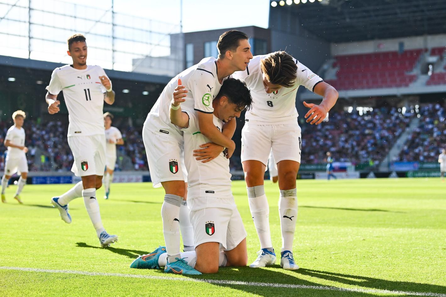 TRNAVA, SLOVAKIA - June 21: Giuseppe Ambrosino Di Bruttopilo of Italy, centre, celebrates with teammates Fabio Miretti, left, and Cesare Casadei after scoring his side\\'s first goal during the UEFA European Under-19 Championship group A match between Slovakia and Italy on June 21, 2022 at the Trnava Stadium in Trnava, Slovakia. (Photo by Seb Daly - UEFA/UEFA via Sportsfile)