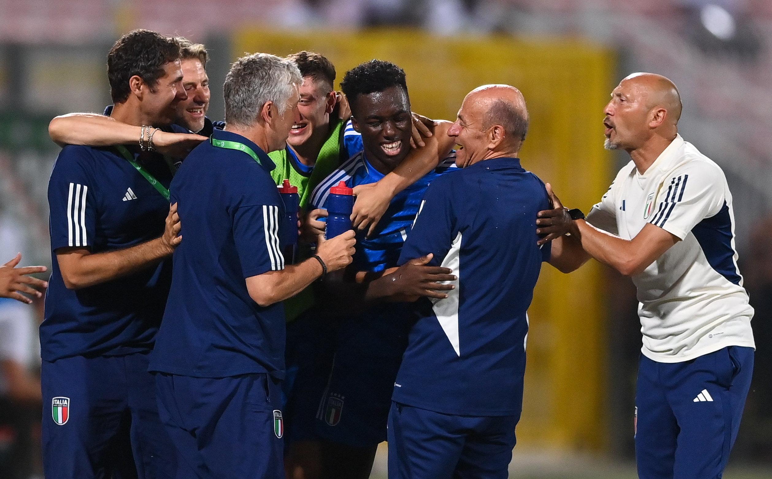 TA' QALI, MALTA - JULY 16: Michael Olabode Kayode of Italy is congratulated by teammates and backroom staff after scoring their side's first goal during the UEFA European Under-19 Championship 2022/23 final match between Portugal and Italy at the National Stadium on July 16, 2023 in Ta' Qali, Malta. (Photo by Seb Daly - Sportsfile/UEFA via Getty Images)