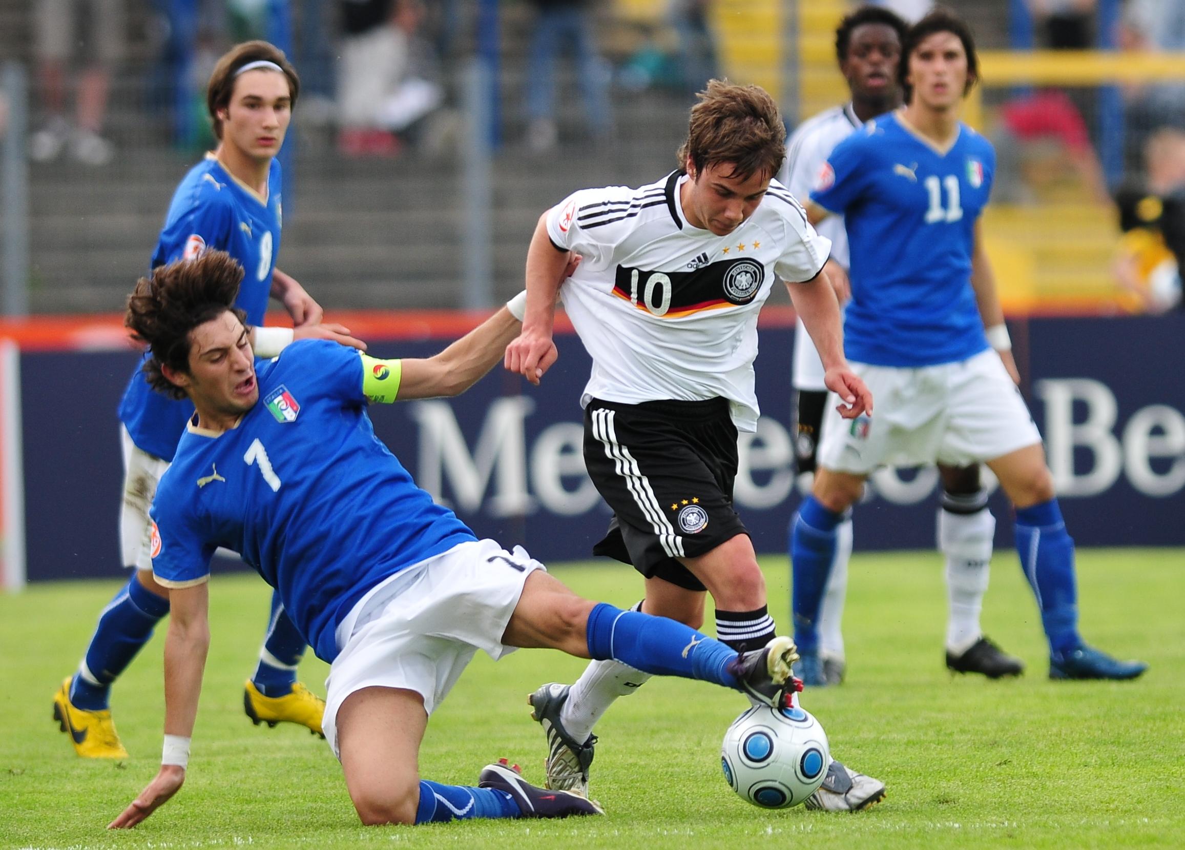 DESSAU GERMANY - MAY 15: Simone Sini of Italy (L) and Mario Goetze of Germany battle for the ball during the Uefa U17 European Championship between Germany and Italy at the Paul Greifzu stadium on May 15, 2009 in Dessau, Germany. (Photo by Enrico Radloff/Bongarts/Getty Images)