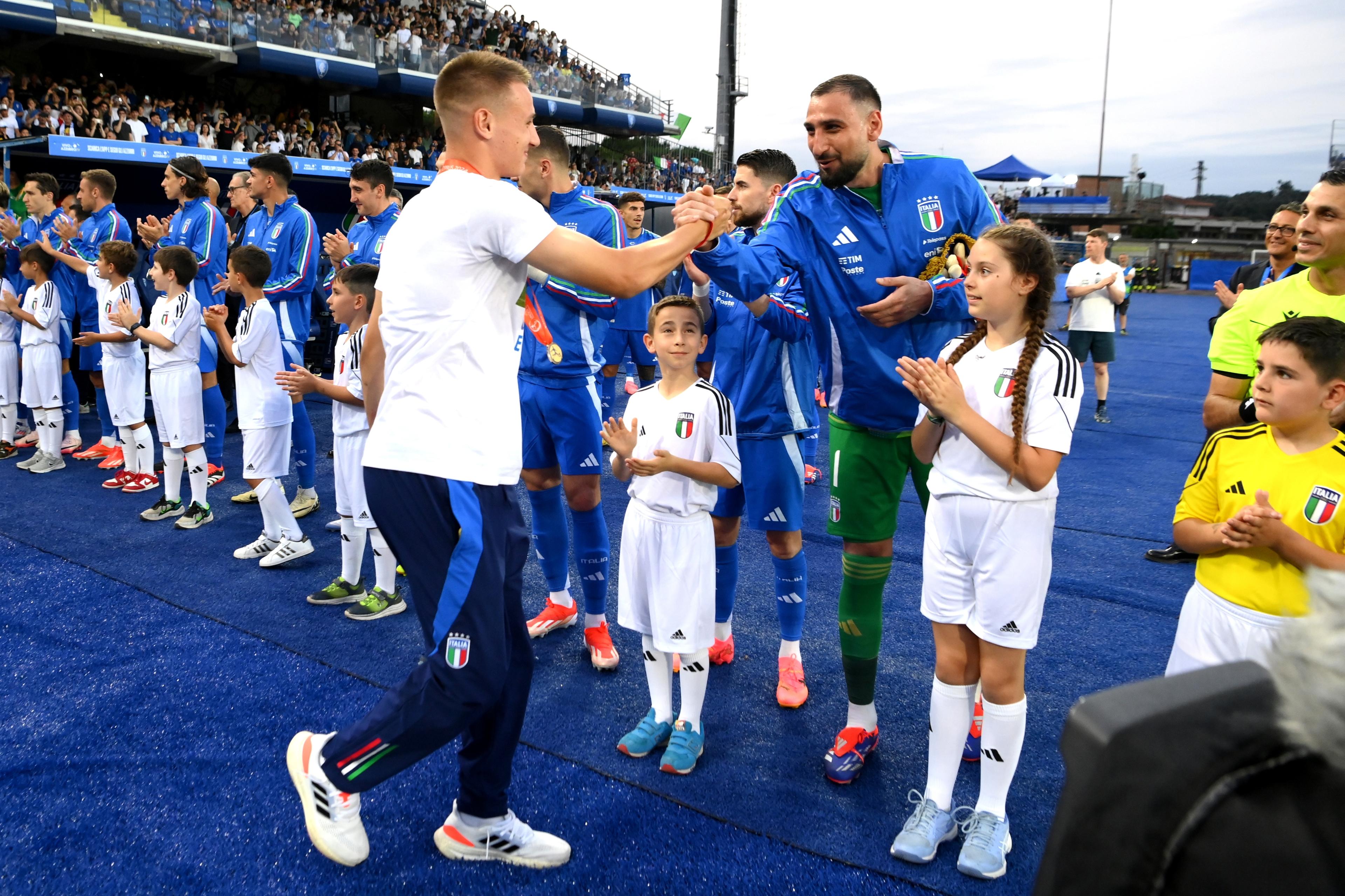 EMPOLI, ITALY - JUNE 09: Francesco Camarda of Italy U17 salutes Gianluigi Donnarumma of Italy before International Friendly beetween Italy and Bosnia & Herzegovina at Stadio Carlo Castellani on June 09, 2024 in Empoli, Italy. (Photo by Claudio Villa/Getty Images)