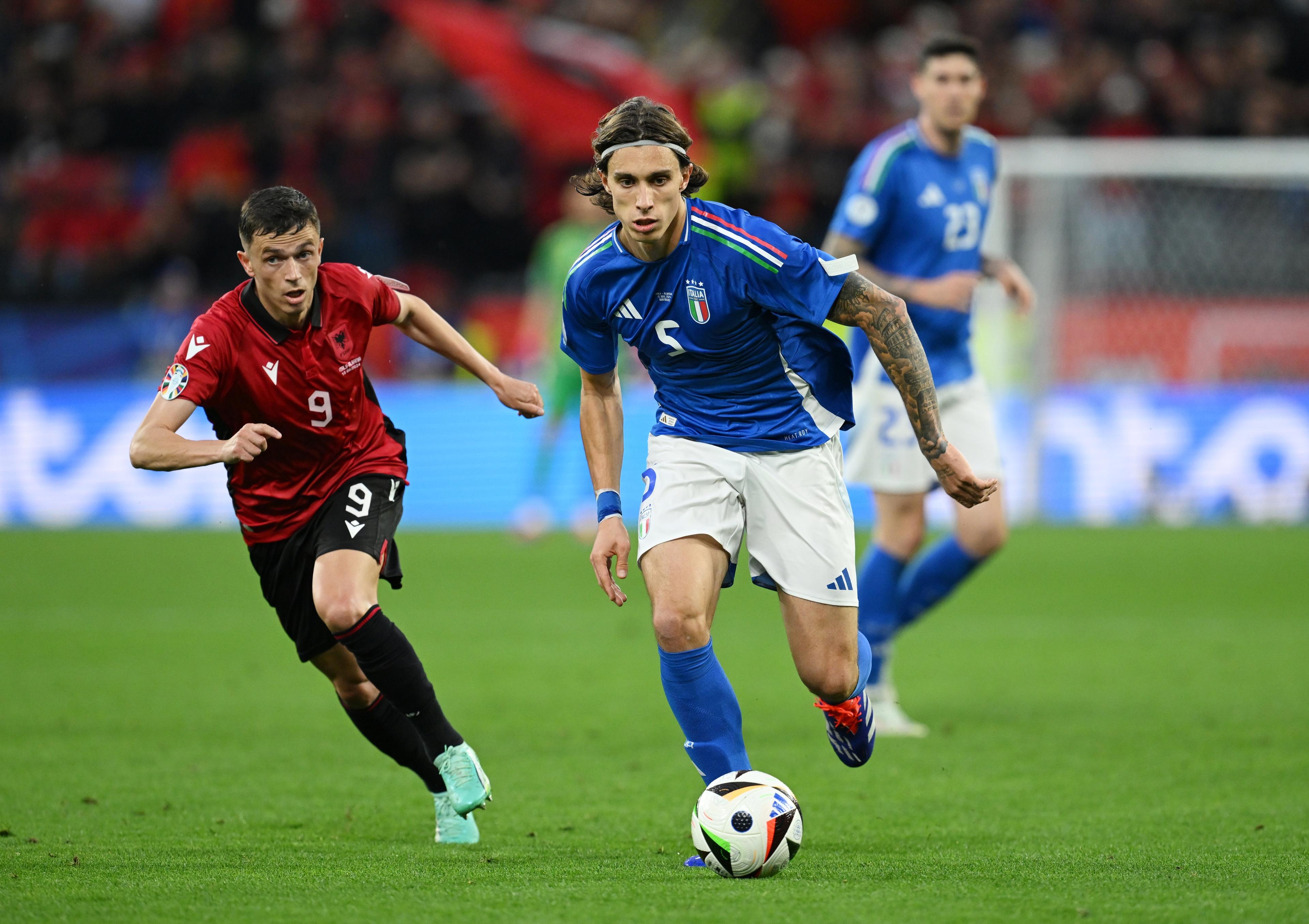DORTMUND, GERMANY - JUNE 15: Riccardo Calafiori of Italy runs with the ball whilst under pressure from Jasir Asani of Albania during the UEFA EURO 2024 group stage match between Italy and Albania at Football Stadium Dortmund on June 15, 2024 in Dortmund, Germany. (Photo by Claudio Villa/Getty Images for FIGC)