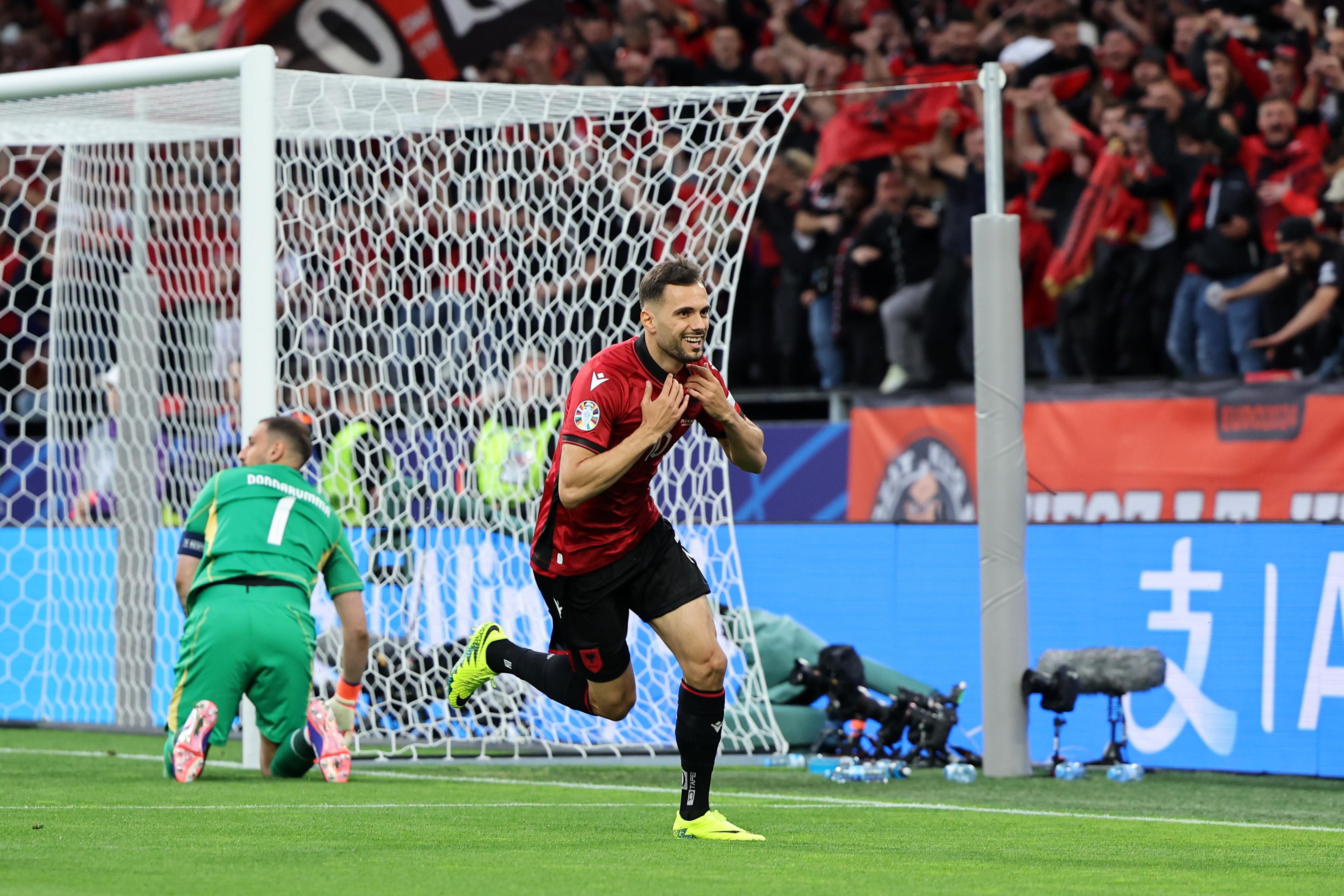 DORTMUND, GERMANY - JUNE 15: Nedim Bajrami of Albania celebrates scoring his team's first goal as Gianluigi Donnarumma of Italy reacts after failing to make a save during the UEFA EURO 2024 group stage match between Italy and Albania at Football Stadium Dortmund on June 15, 2024 in Dortmund, Germany. (Photo by Matt McNulty - UEFA/UEFA via Getty Images)