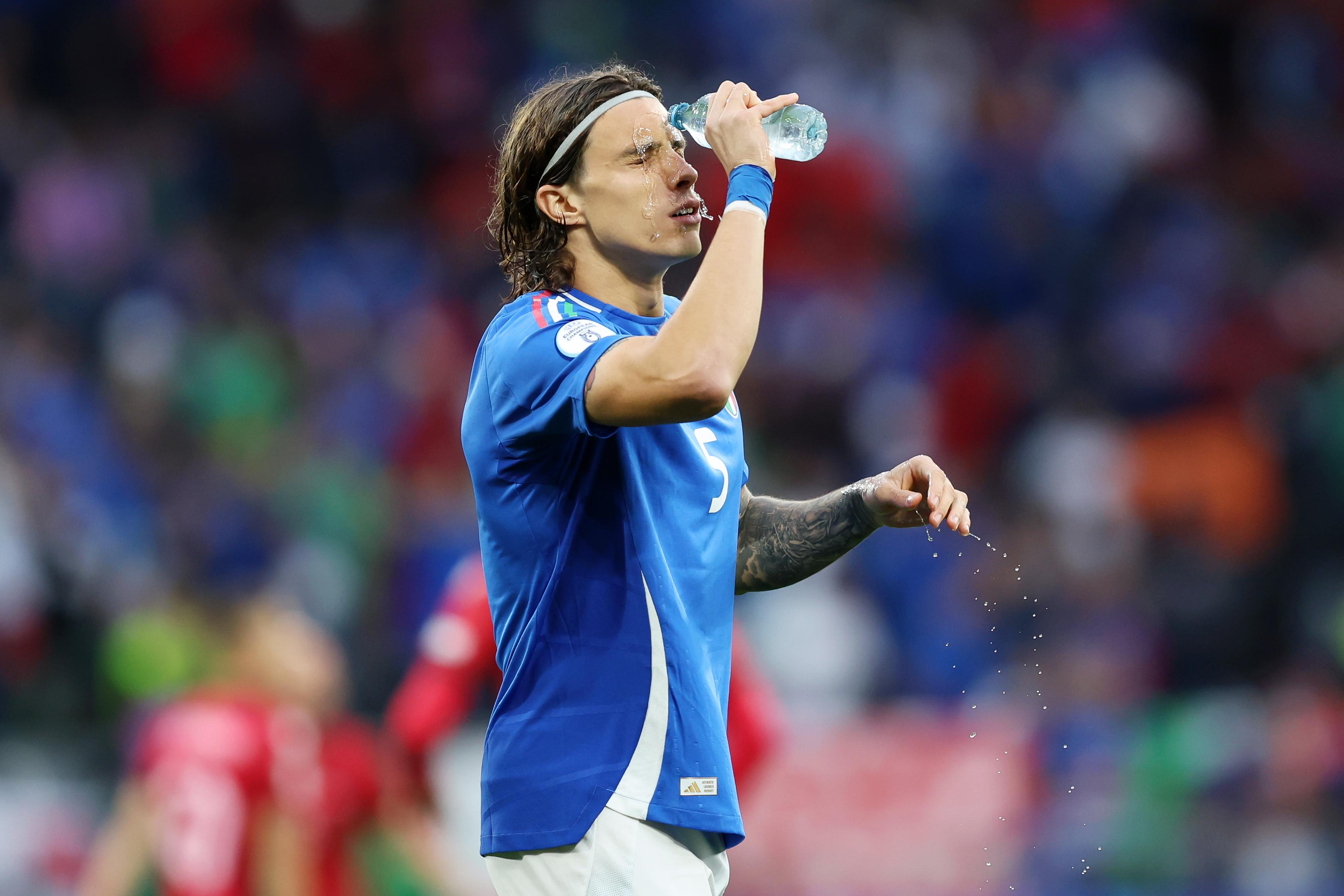 DORTMUND, GERMANY - JUNE 15: Riccardo Calafiori of Italy pours water over his face during the UEFA EURO 2024 group stage match between Italy and Albania at Football Stadium Dortmund on June 15, 2024 in Dortmund, Germany. (Photo by Matt McNulty - UEFA/UEFA via Getty Images)