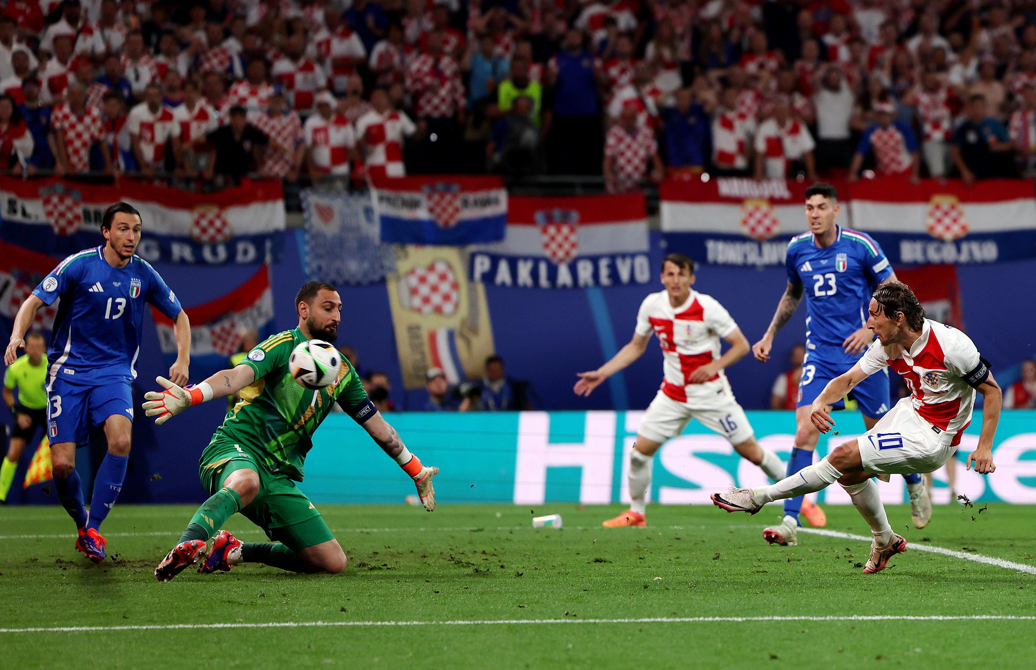 LEIPZIG, GERMANY - JUNE 24: Luka Modric of Croatia scores his team's first goal as Gianluigi Donnarumma of Italy fails to make a save during the UEFA EURO 2024 group stage match between Croatia and Italy at Football Stadium Leipzig on June 24, 2024 in Leipzig, Germany. (Photo by Boris Streubel - UEFA/UEFA via Getty Images)