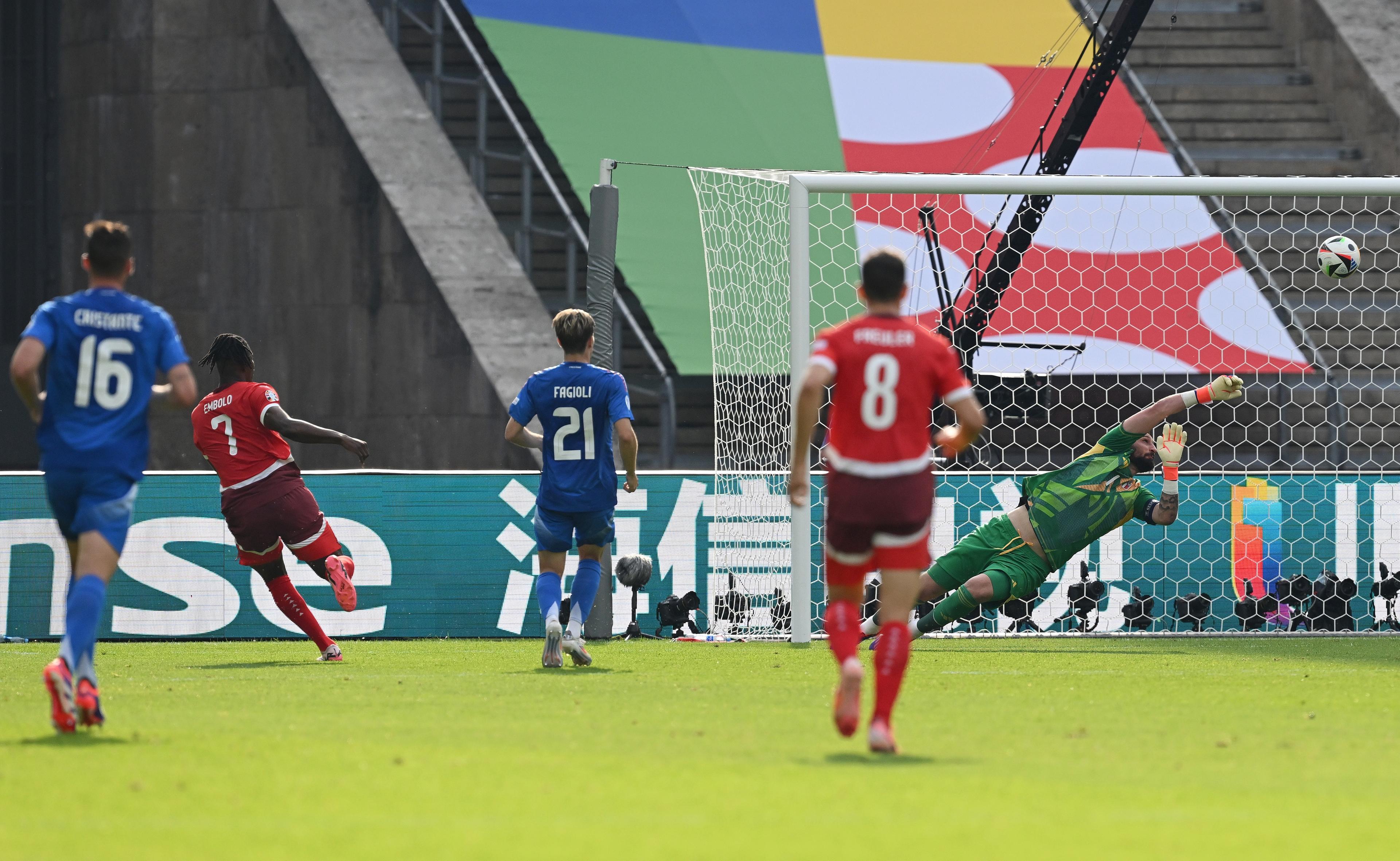 BERLIN, GERMANY - JUNE 29: Gianluigi Donnarumma of Italy makes a save from Noah Okafor of Switzerland during the UEFA EURO 2024 round of 16 match between Switzerland and Italy at Olympiastadion on June 29, 2024 in Berlin, Germany. (Photo by Claudio Villa/Getty Images for FIGC)