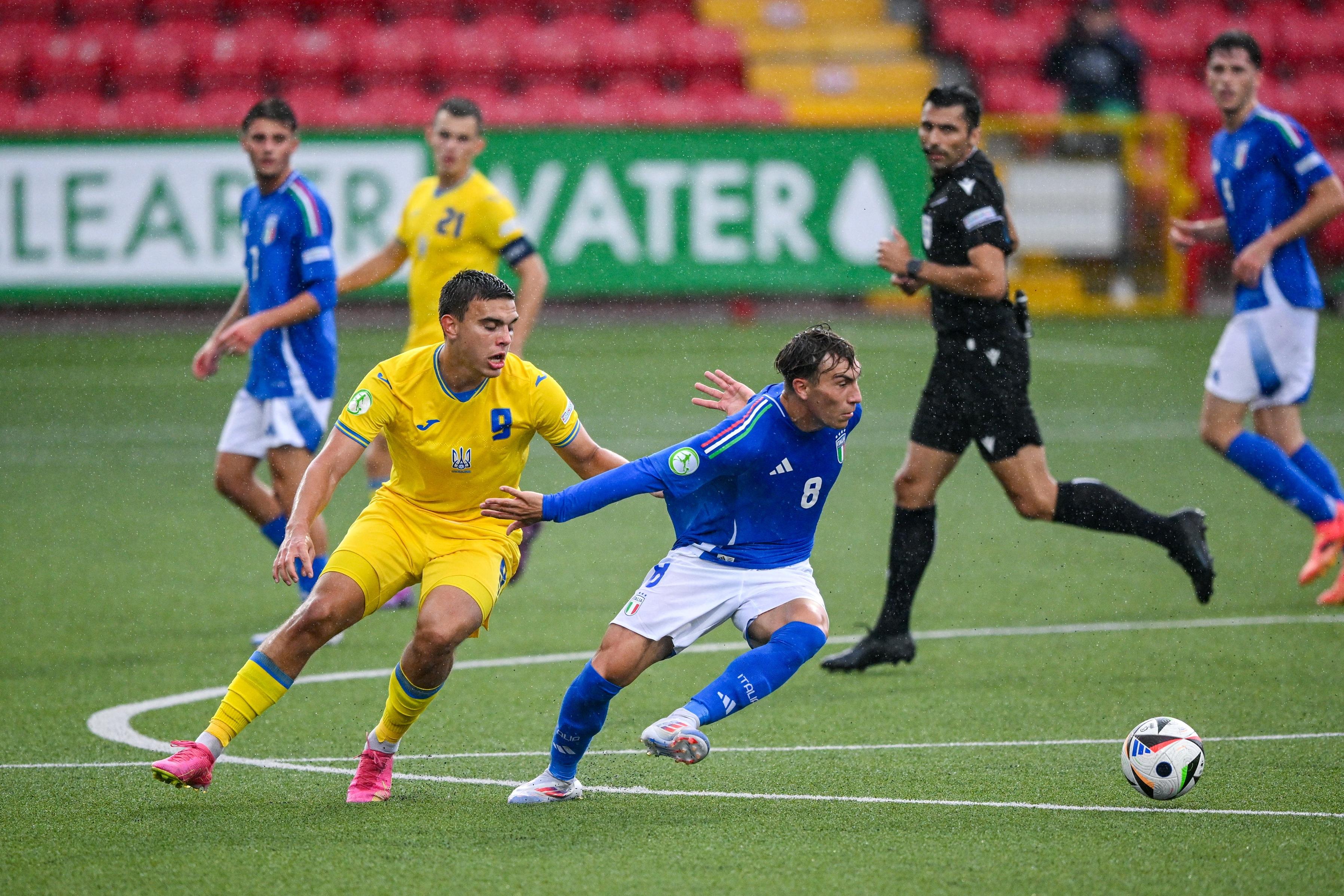 LARNE, NORTHERN IRELAND - JULY 21: Luca Di Maggio of Italy in action against Matvii Ponomarenko of Ukraine during the UEFA European Under-19 Championship 2024 Group A match between Ukraine and Italy at Inver Park on July 21, 2024 in Larne, Northern Ireland. (Photo by Ramsey Cardy - Sportsfile/UEFA via Getty Images)
