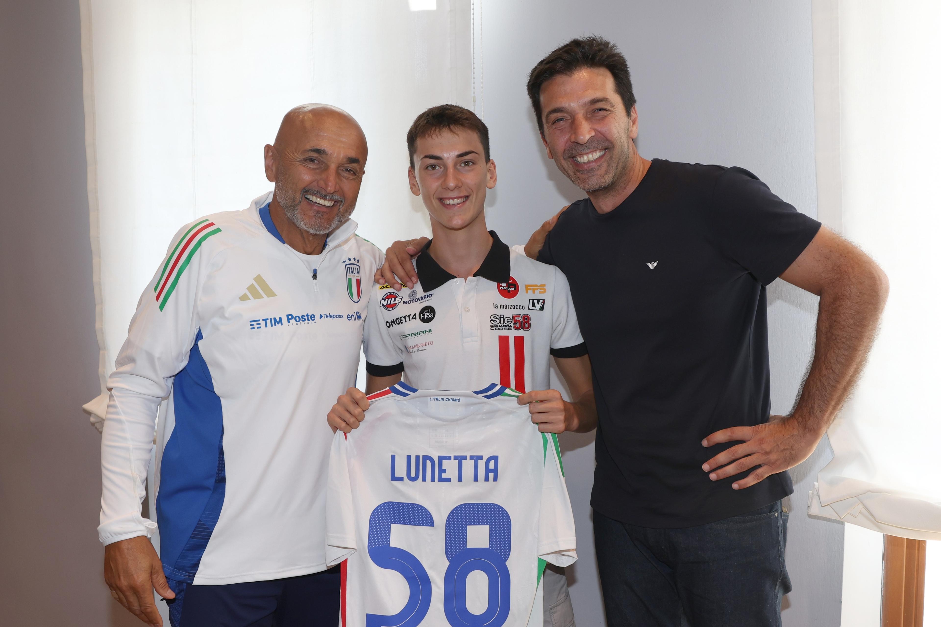 FLORENCE, ITALY - SEPTEMBER 04: Motorcyclist Luca Lunetta of Italy\\'s Sic58 Squadra Corse Honda, poses in a photo with head coach Italy  Luciano Spalletti and head of Italy delegation Gianluigi Buffon, during a visit to the Italian national football team\\'s training camp at Centro Tecnico Federale di Coverciano on September 04, 2024 in Florence, Italy. (Photo by Claudio Villa/Getty Images)