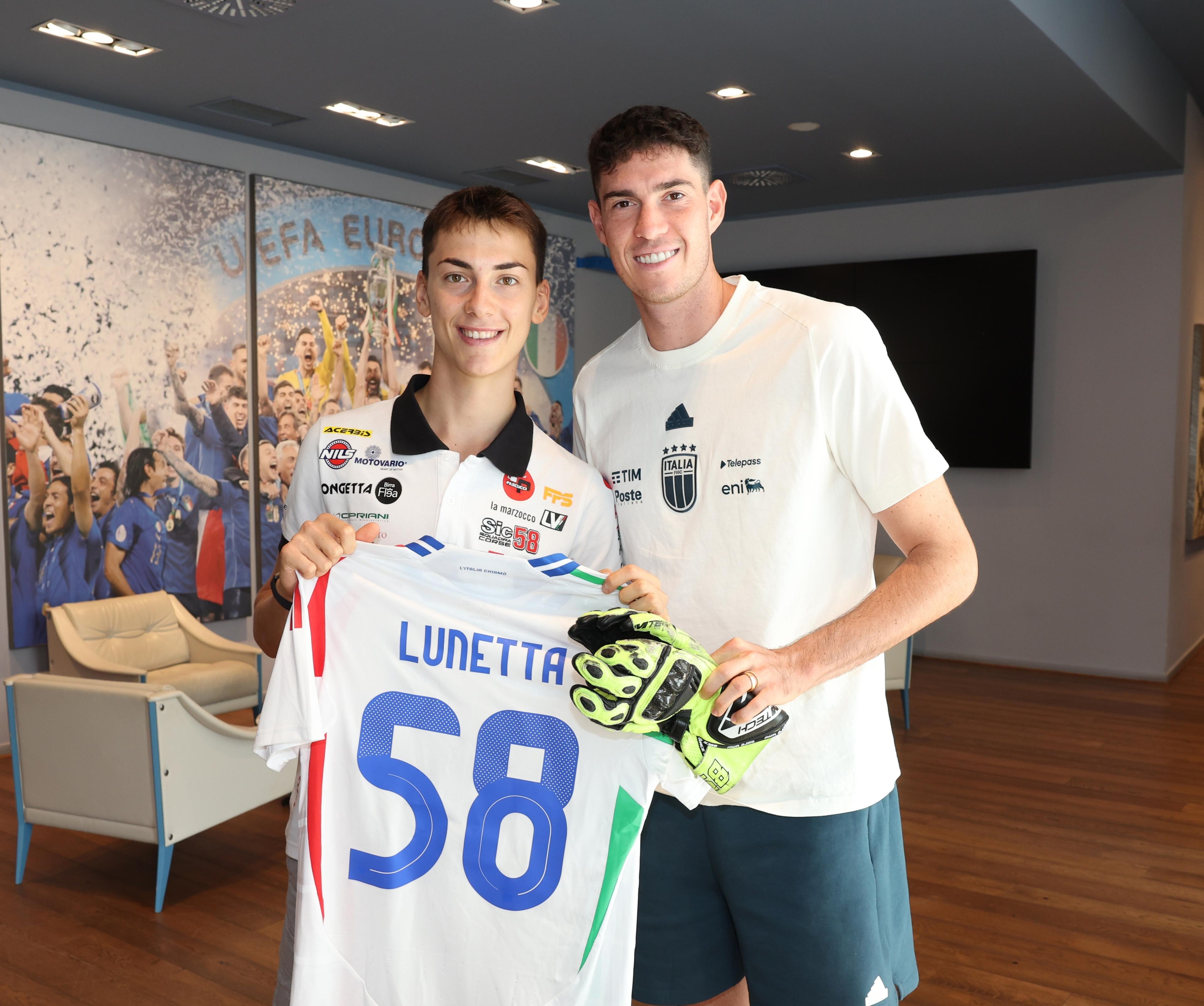 FLORENCE, ITALY - SEPTEMBER 04: Motorcyclist Luca Lunetta of Italy's Sic58 Squadra Corse Honda, poses in a photo with Alessandro Bastoni of Italy, during a visit to the Italian national football team's training camp at Centro Tecnico Federale di Coverciano on September 04, 2024 in Florence, Italy. (Photo by Claudio Villa/Getty Images)