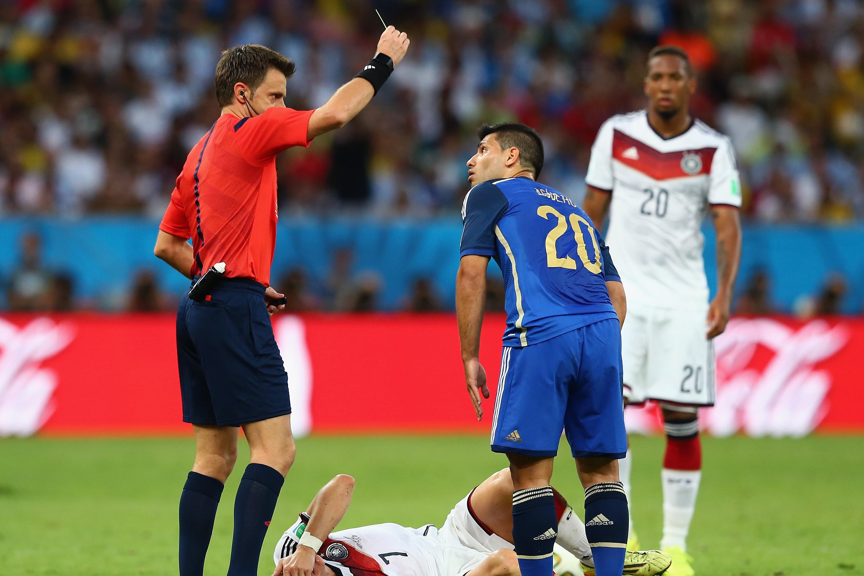 RIO DE JANEIRO, BRAZIL - JULY 13: Sergio Aguero of Argentina is shown a yellow card by referee Nicola Rizzoli after a challenge on Bastian Schweinsteiger of Germany during the 2014 FIFA World Cup Brazil Final match between Germany and Argentina at Maracana on July 13, 2014 in Rio de Janeiro, Brazil. (Photo by Martin Rose/Getty Images)