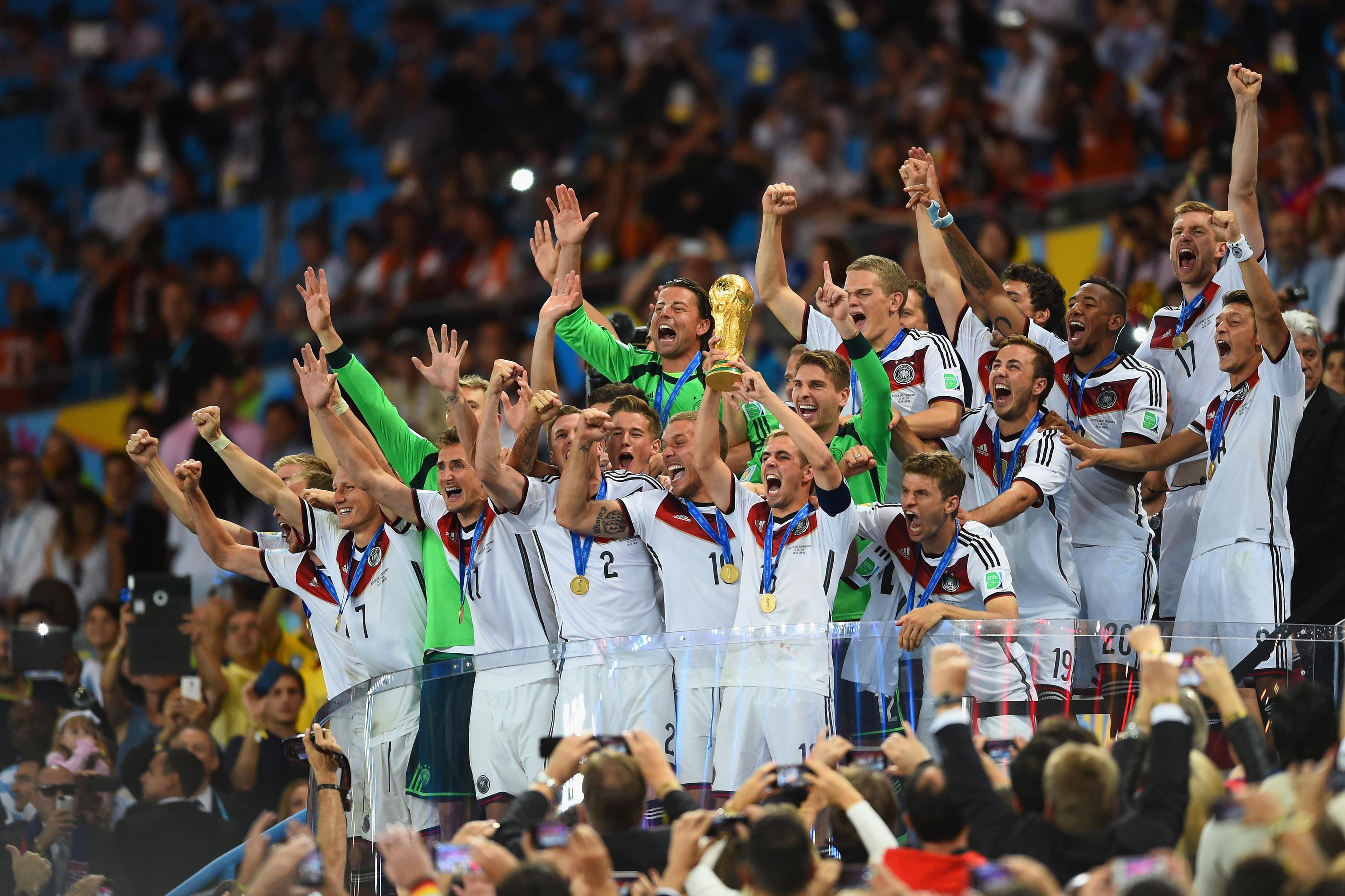 RIO DE JANEIRO, BRAZIL - JULY 13: Philipp Lahm of Germany lifts the World Cup trophy after defeating Argentina 1-0 in extra time during the 2014 FIFA World Cup Brazil Final match between Germany and Argentina at Maracana on July 13, 2014 in Rio de Janeiro, Brazil.  (Photo by Matthias Hangst/Getty Images)