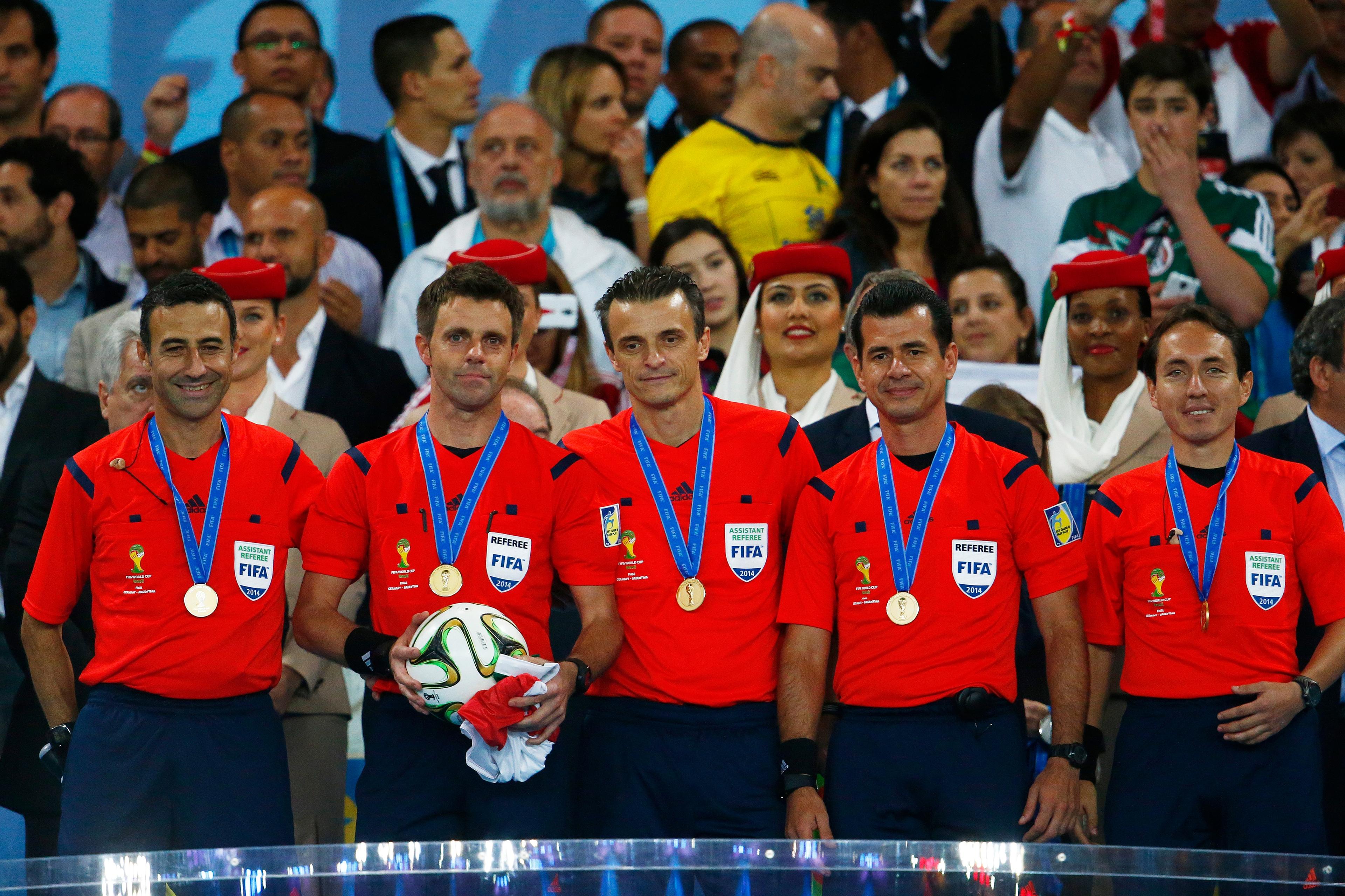 RIO DE JANEIRO, BRAZIL - JULY 13: Match officials are presented with their medals after the 2014 FIFA World Cup Brazil Final match between Germany and Argentina at Maracana on July 13, 2014 in Rio de Janeiro, Brazil. (Photo by Clive Rose/Getty Images)