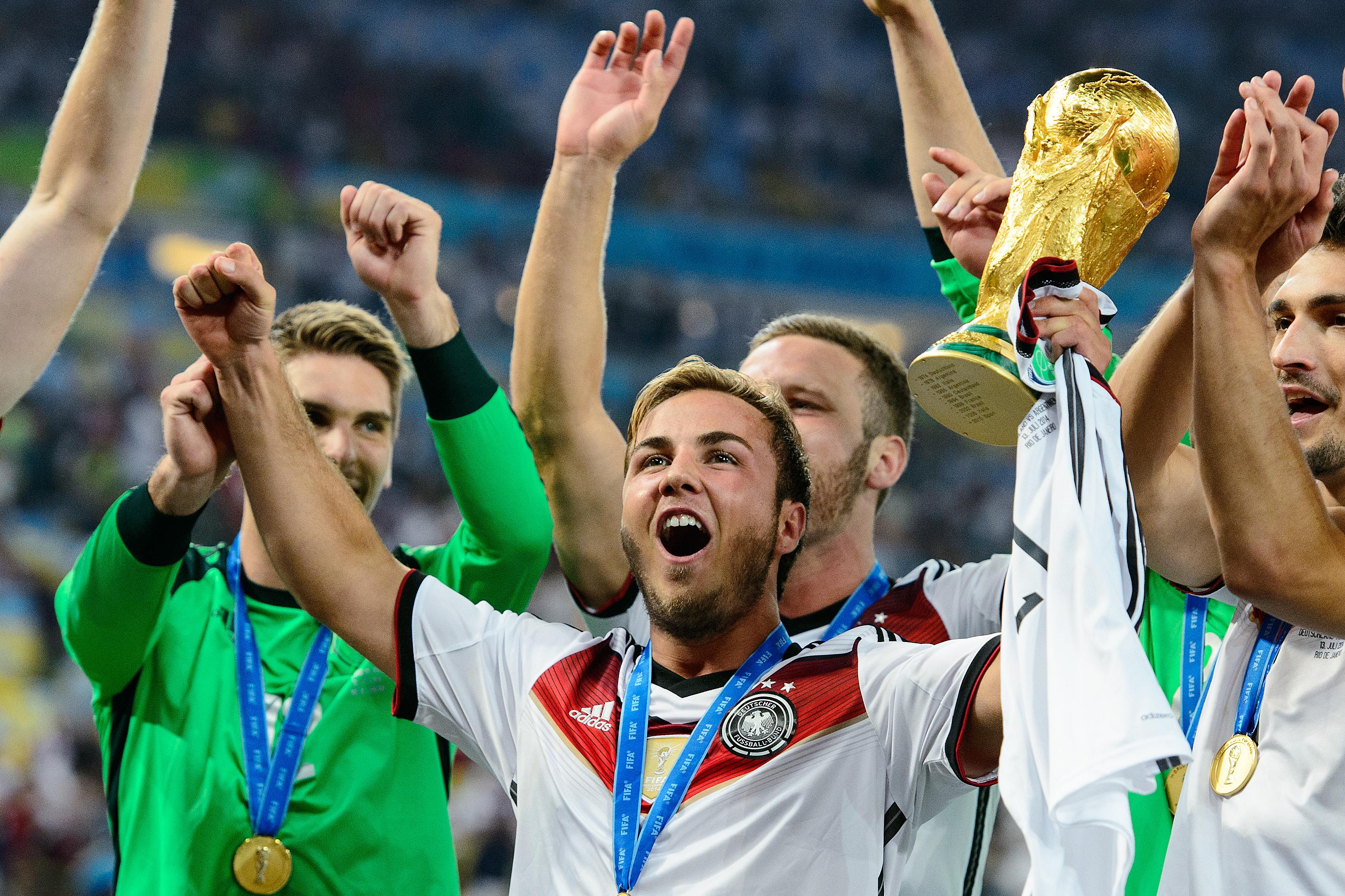 RIO DE JANEIRO, BRAZIL - JULY 13: Mario Goetze celebrate with the World Cup trophy after defeating Argentina 1-0 in extra time during the 2014 FIFA World Cup Brazil Final match between Germany and Argentina at Maracana on July 13, 2014 in Rio de Janeiro, Brazil. (Photo by Matthias Hangst/Getty Images)
