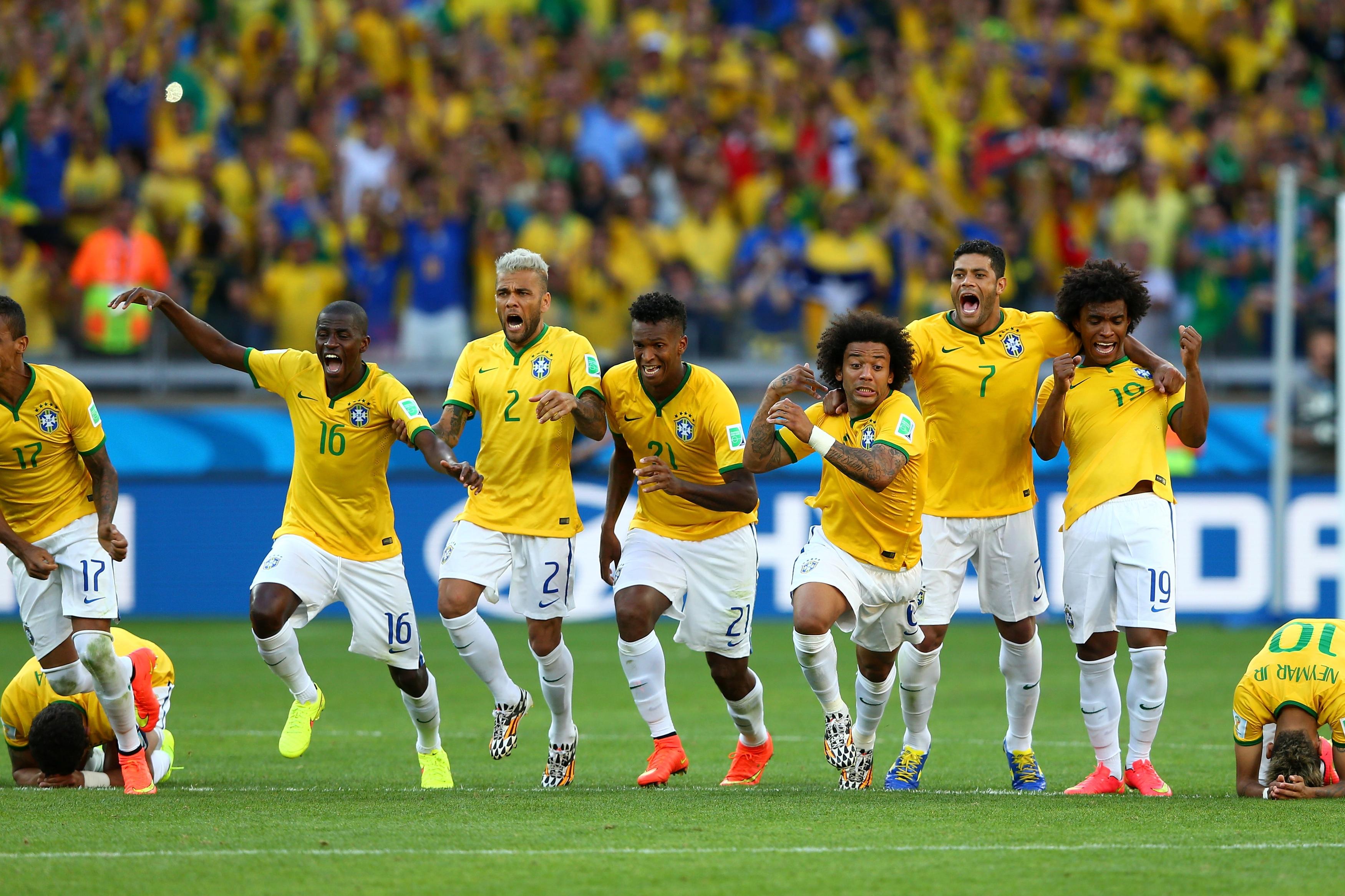 BELO HORIZONTE, BRAZIL - JUNE 28: (L-R) Thiago Silva, Luiz Gustavo, Ramires, Dani Alves, Jo, Marcelo, Hulk, Willian and Neymar of Brazil celebrate after defeating Chile in a penalty shootout during the 2014 FIFA World Cup Brazil round of 16 match between Brazil and Chile at Estadio Mineirao on June 28, 2014 in Belo Horizonte, Brazil. (Photo by Quinn Rooney/Getty Images)