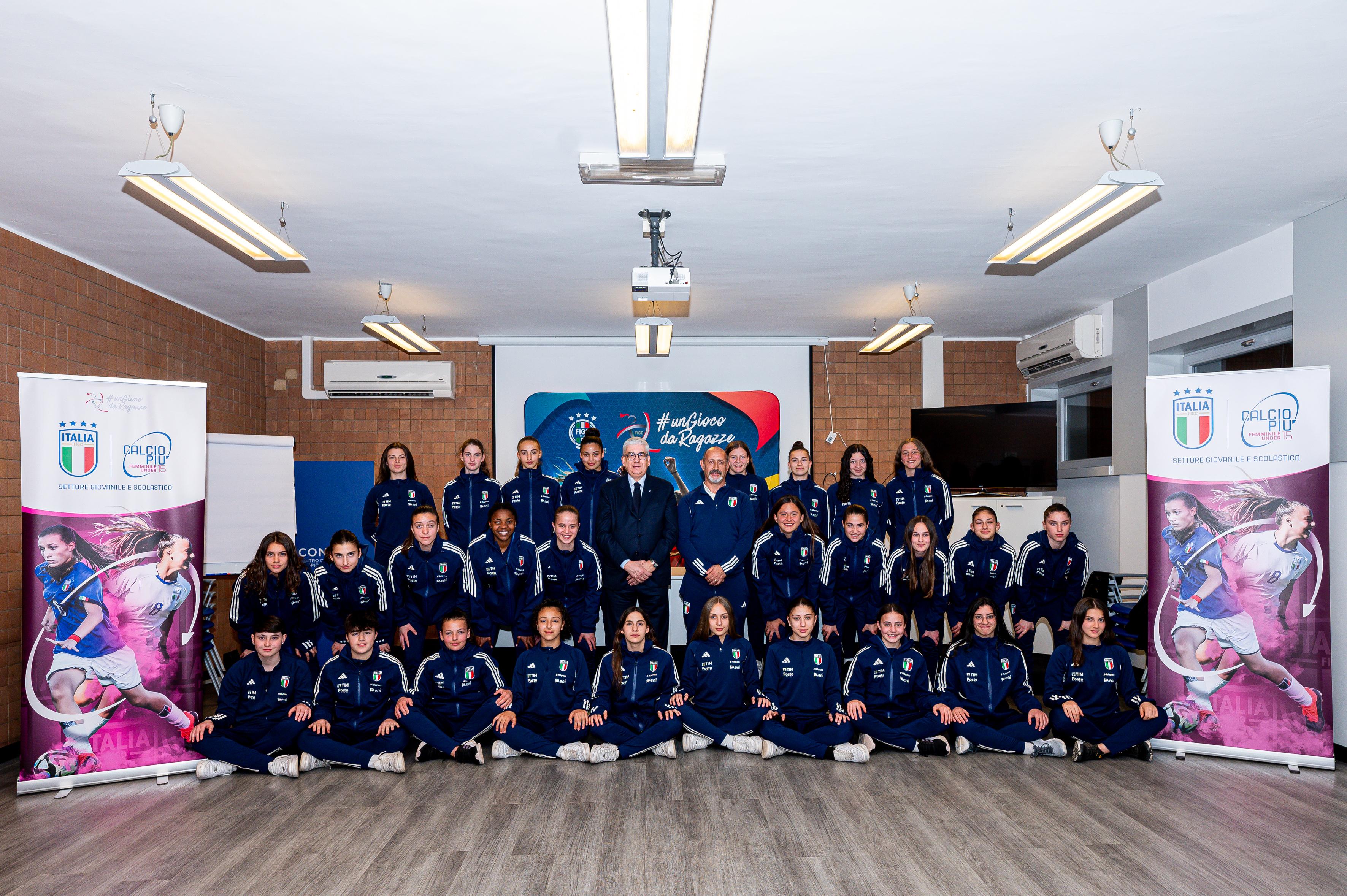 TIRRENIA, ITALY - MARCH 6: Vito Tisci, chairman of Figc/Sgs, and Massimo Tell, Grassroots manager Figc (center), pose with young players for a group picture during the filming day with the Calcio+15 - WU15 for the UEFA Grassroots Awards 2024 at Centro Tecnico Tirrenia on March 6, 2024 in Tirrenia, Italy. (Photo by Simone Arveda - UEFA/UEFA via Getty Images)
