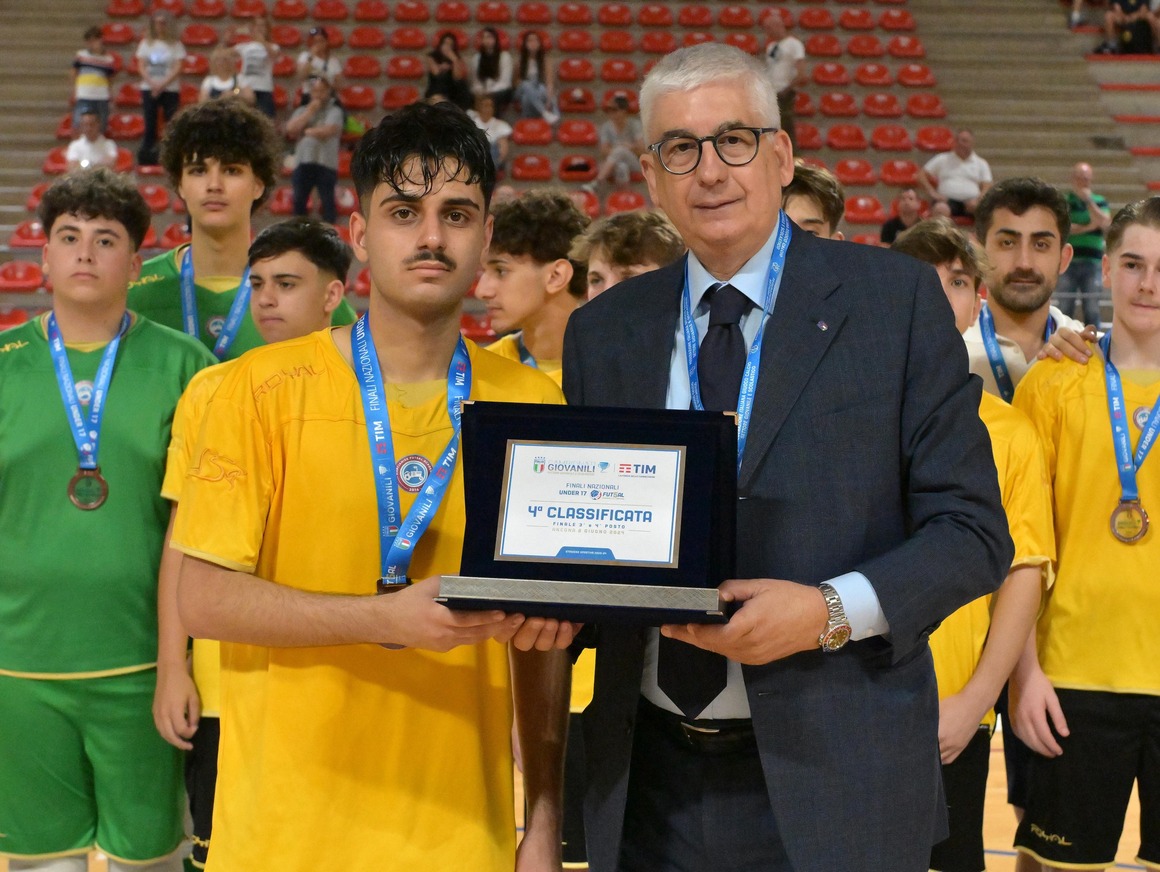 ANCONA, ITALY - JUNE 02: Vito Roberto Tisci President of the Youth and School Sector of the FIGC awards Cristiano Delle Curti as captain of team of Marcianise U17 fourth place after FIGC SGS Under 15 & Under 17 Futsal Finals match betwween Marcianise U17 and Fenice Veneziamestre U17 at Pala Rossini on June 02, 2024 in Ancona, Italy. (Photo by Giuseppe Bellini/Getty Images)