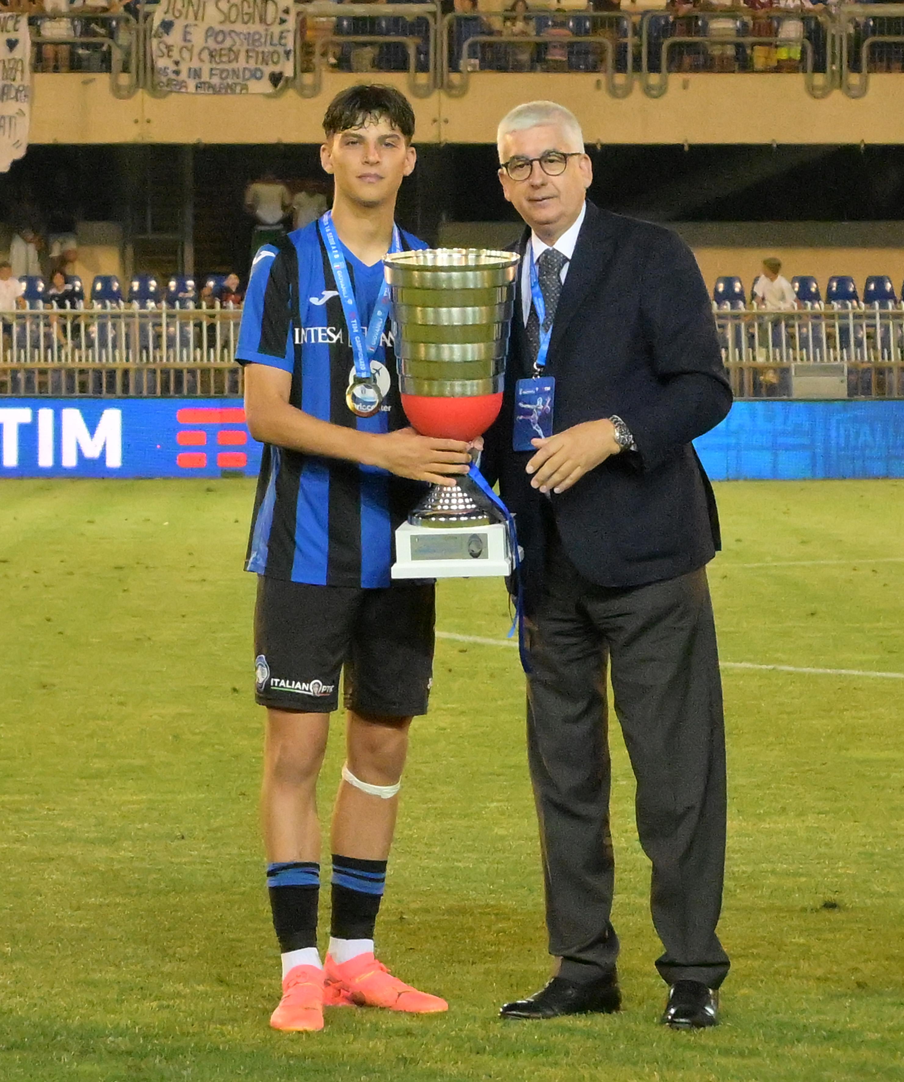SAN BENEDETTO DEL TRONTO, ITALY - JUNE 22: Vito Roberto Tisci President of the Youth and School Sector of the FIGC awards, and Alessandro Rinaldi as captain of Team Atalanta BC after the Serie A & B U16 Final match between Atalanta BC and AC Milan at Stadio Riviera delle Palme on June 22, 2024 in San Benedetto del Tronto, Italy. (Photo by Giuseppe Bellini/Getty Images)