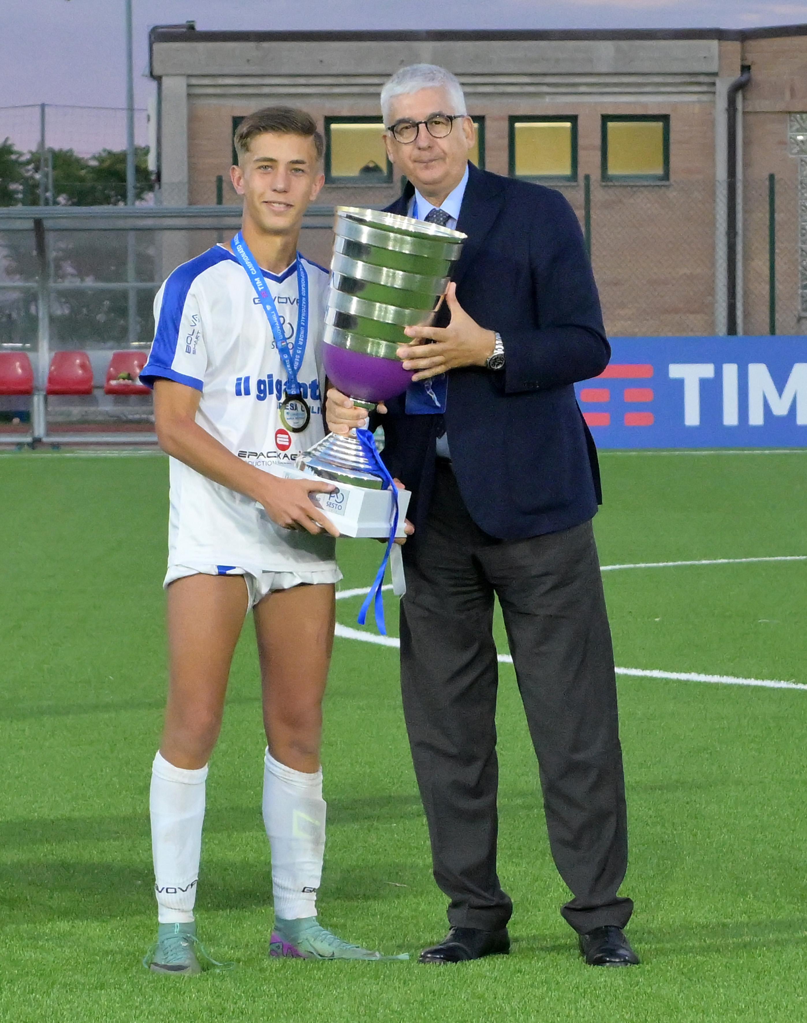 RECANATI, ITALY - JUNE 26: Vito Roberto Tisci President of the Youth and School Sector of the FIGC awards, and Filippo Signore of as captain of Team Pro Sesto the U15 Serie C Final match between Pro Sesto and Arezzo at on June 26, 2024 in Recanati, Italy. (Photo by Giuseppe Bellini/Getty Images)
