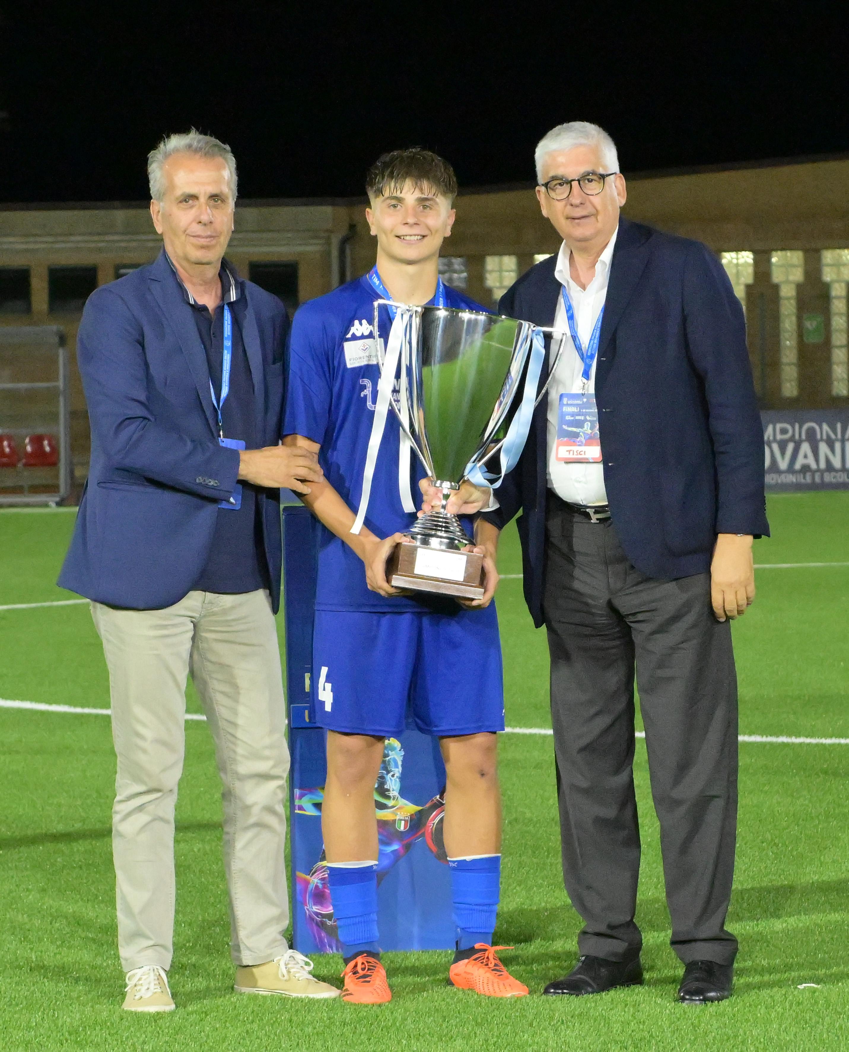 RECANATI, ITALY - JUNE 29: Vito Roberto Tisci President of the Youth and School Sector of the FIGC awards, and Riccardo Guidorizzi of as captain of Team Affrico during the U17 Amateurs Final match between Levante Azzurro and Affricos at on June 29, 2024 in Recanati, Italy. (Photo by Giuseppe Bellini/Getty Images)