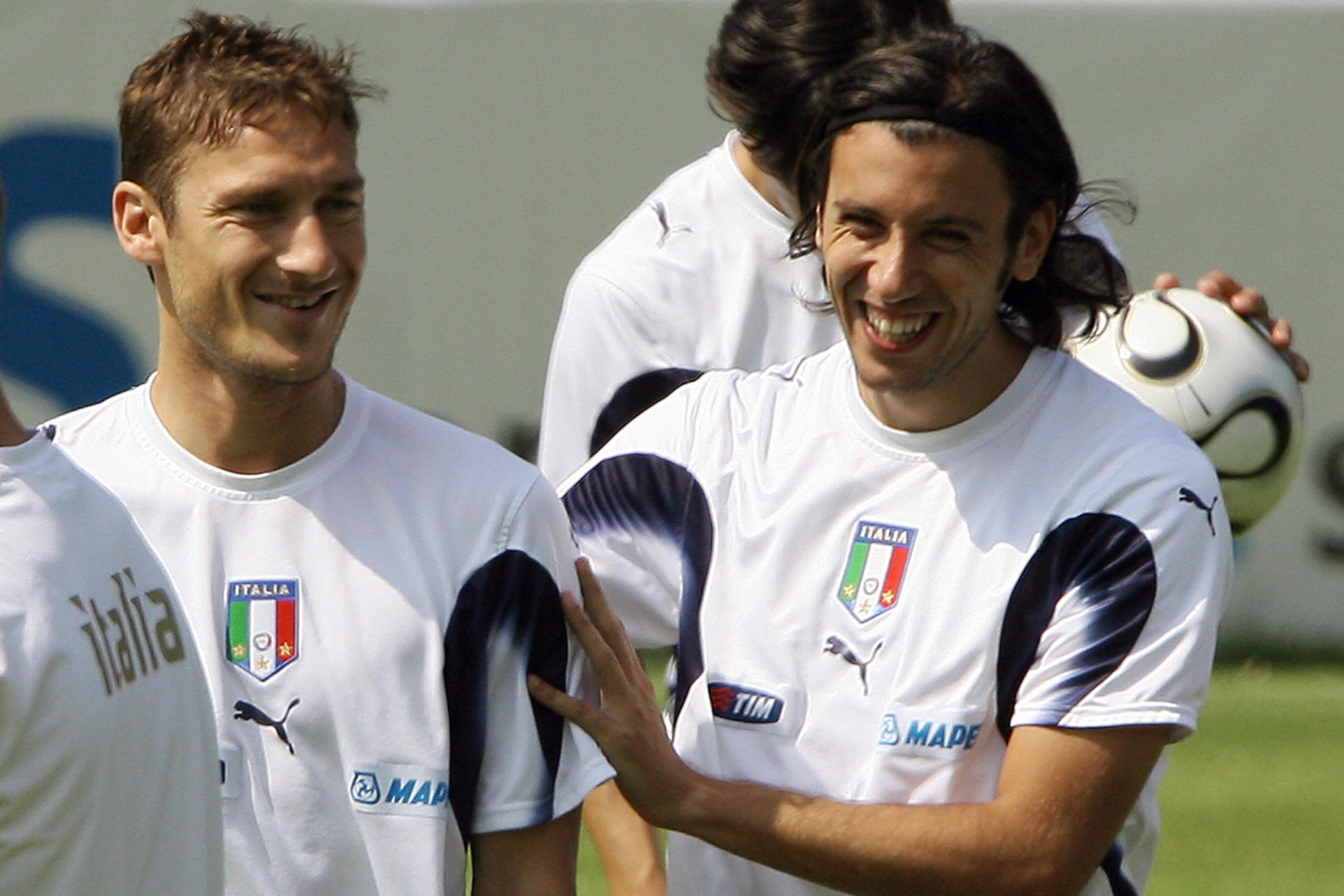 Duisburg, GERMANY:  Italian forward Francesco Totti (L) jokes with teammate Cristian Zaccardo during a training session 30 June 2006 in Duisburg, on the eve of their quarter final of the football World Cup 2006 against Ukraine in Hamburg.  AFP PHOTO / PATRICK HERTZOG  (Photo credit should read PATRICK HERTZOG/AFP/Getty Images)
