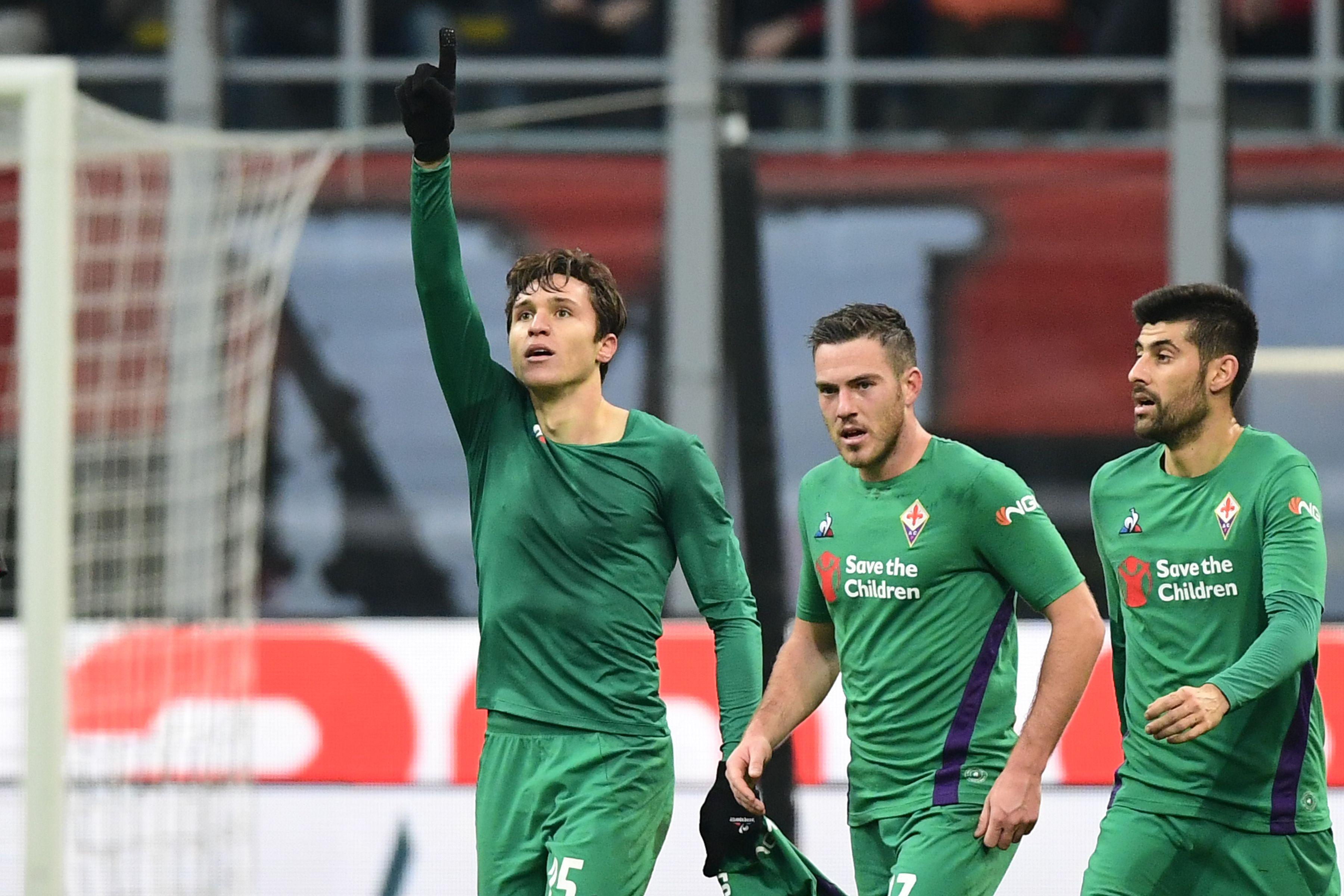 Fiorentina\\'s Italian forward Federico Chiesa (L) celebrates after opening the scoring during the Italian Serie A Football match AC Milan vs Fiorentina on December 22, 2018 at the San Siro stadium in Milan. (Photo by Miguel MEDINA / AFP)        (Photo credit should read MIGUEL MEDINA/AFP/Getty Images)