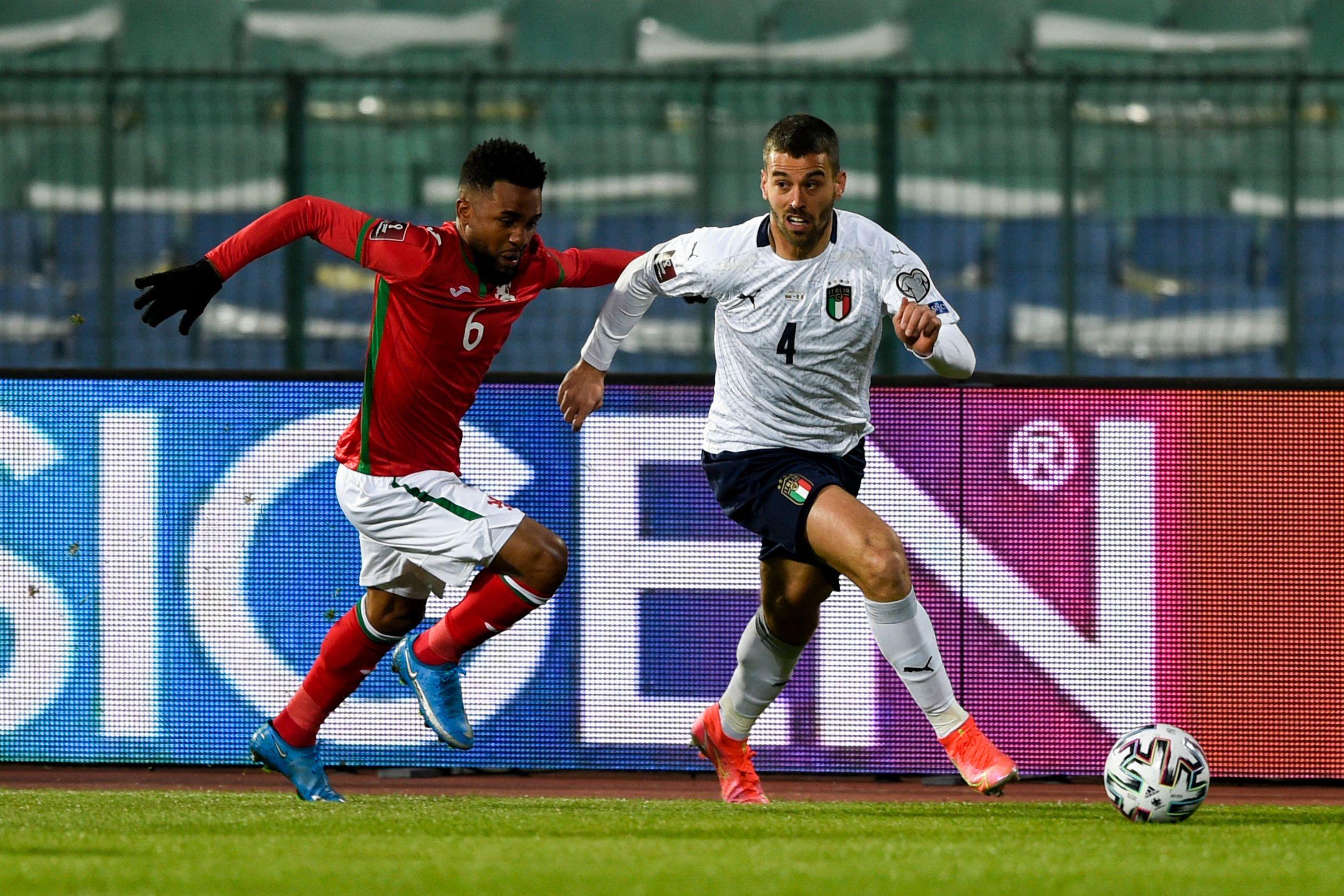 Bulgaria\\'s defender Cicinho (L) challenges Italy\\'s defender Leonardo Spinazzola during the FIFA World Cup Qatar 2022 qualification Group C football match between Bulgaria and Italy at the Vasil Levski Stadium, in Sofia, on March 28, 2021. (Photo by Nikolay DOYCHINOV / AFP) (Photo by NIKOLAY DOYCHINOV/AFP via Getty Images)