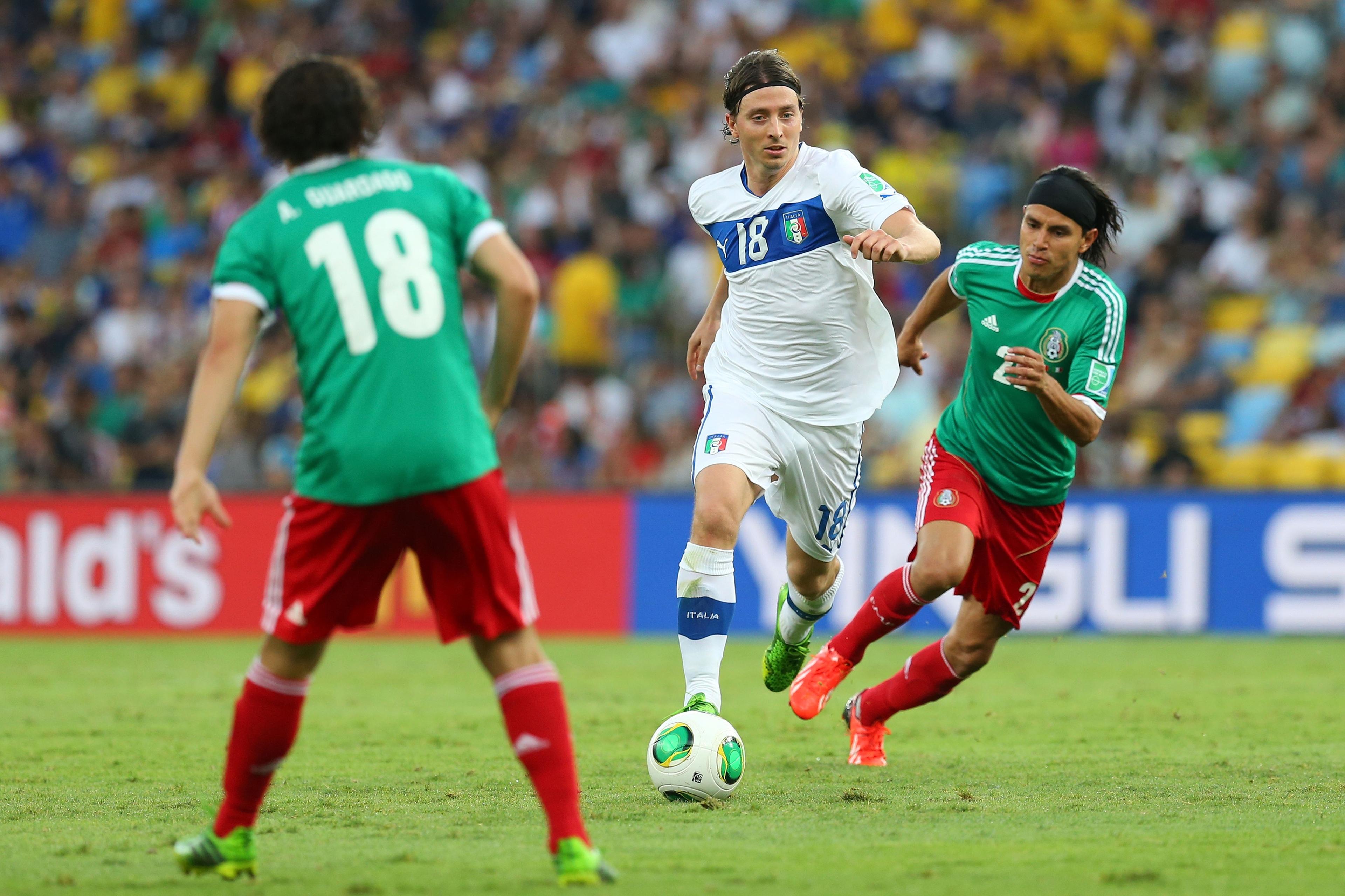 RIO DE JANEIRO, BRAZIL - JUNE 16:  Riccardo Montolivo of Italy competes with Gerardo Flores of Mexico during the FIFA Confederations Cup Brazil 2013 Group A match between Mexico and Italy at the Maracana Stadium on June 16, 2013 in Rio de Janeiro, Brazil.  (Photo by Alex Livesey - FIFA/FIFA via Getty Images)