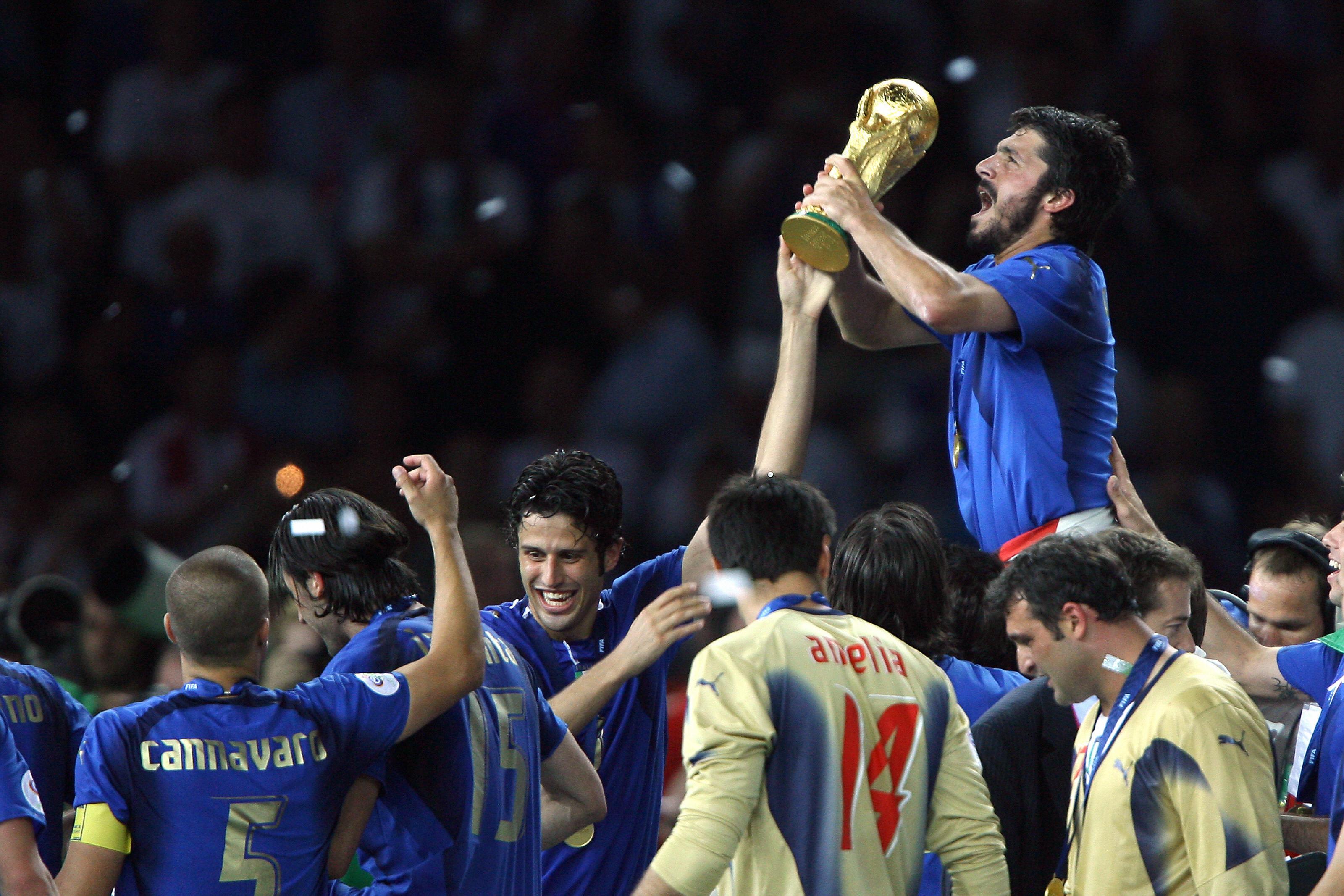 Berlin, GERMANY:  Italian midfielder Gennaro Gattuso (R) celebrates with the trophy after the World Cup 2006 final football game Italy vs.France, 09 July 2006 at Berlin stadium. Italy won the 2006 football World Cup by defeating France on penalties. AFP PHOTO PATRICK HERTZOG  (Photo credit should read PATRICK HERTZOG/AFP via Getty Images)