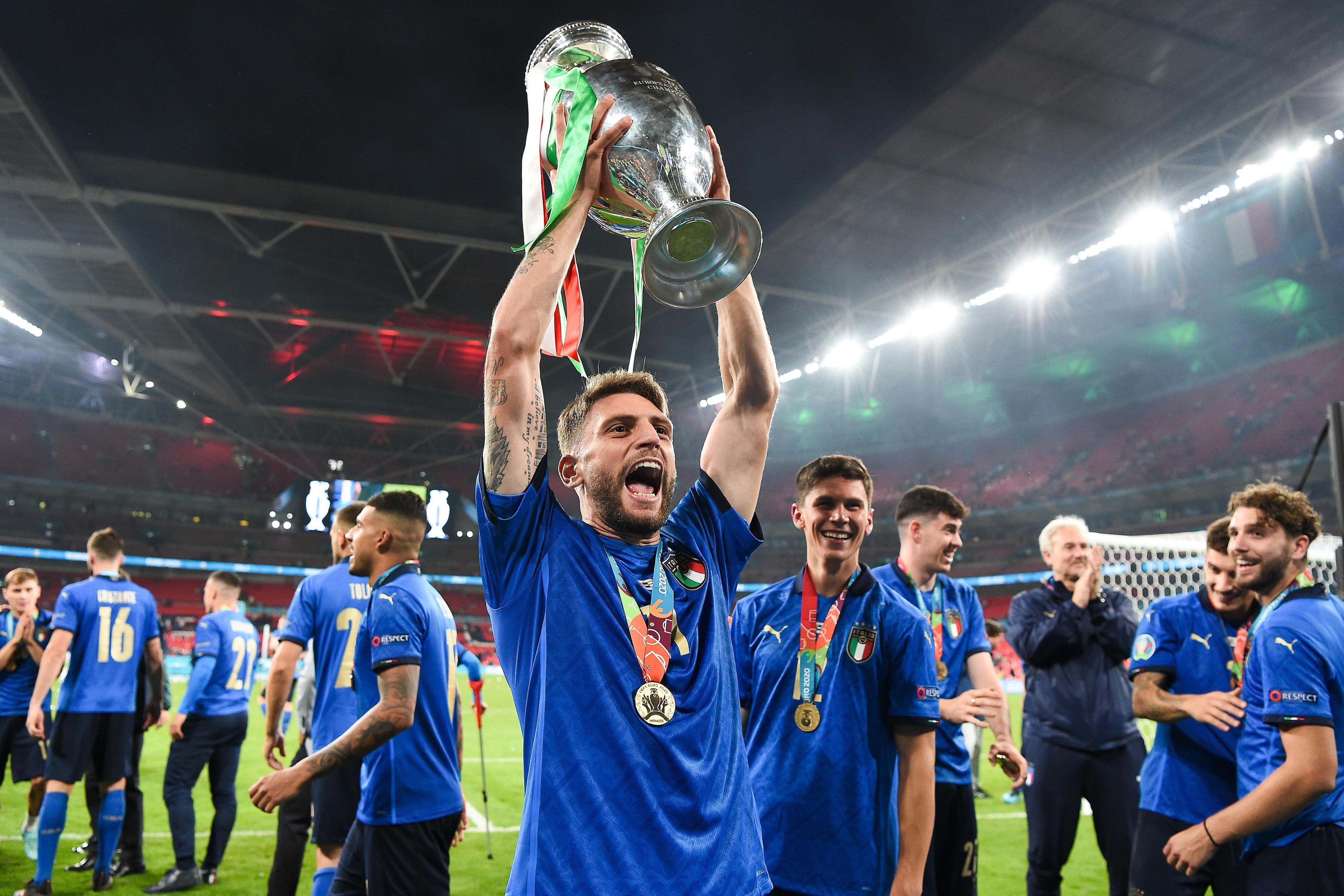 LONDON, ENGLAND - JULY 11: Domenico Berardi of Italy lifts The Henri Delaunay Trophy following his team\\'s victory in the UEFA Euro 2020 Championship Final between Italy and England at Wembley Stadium on July 11, 2021 in London, England. (Photo by Andy Rain - Pool/Getty Images)