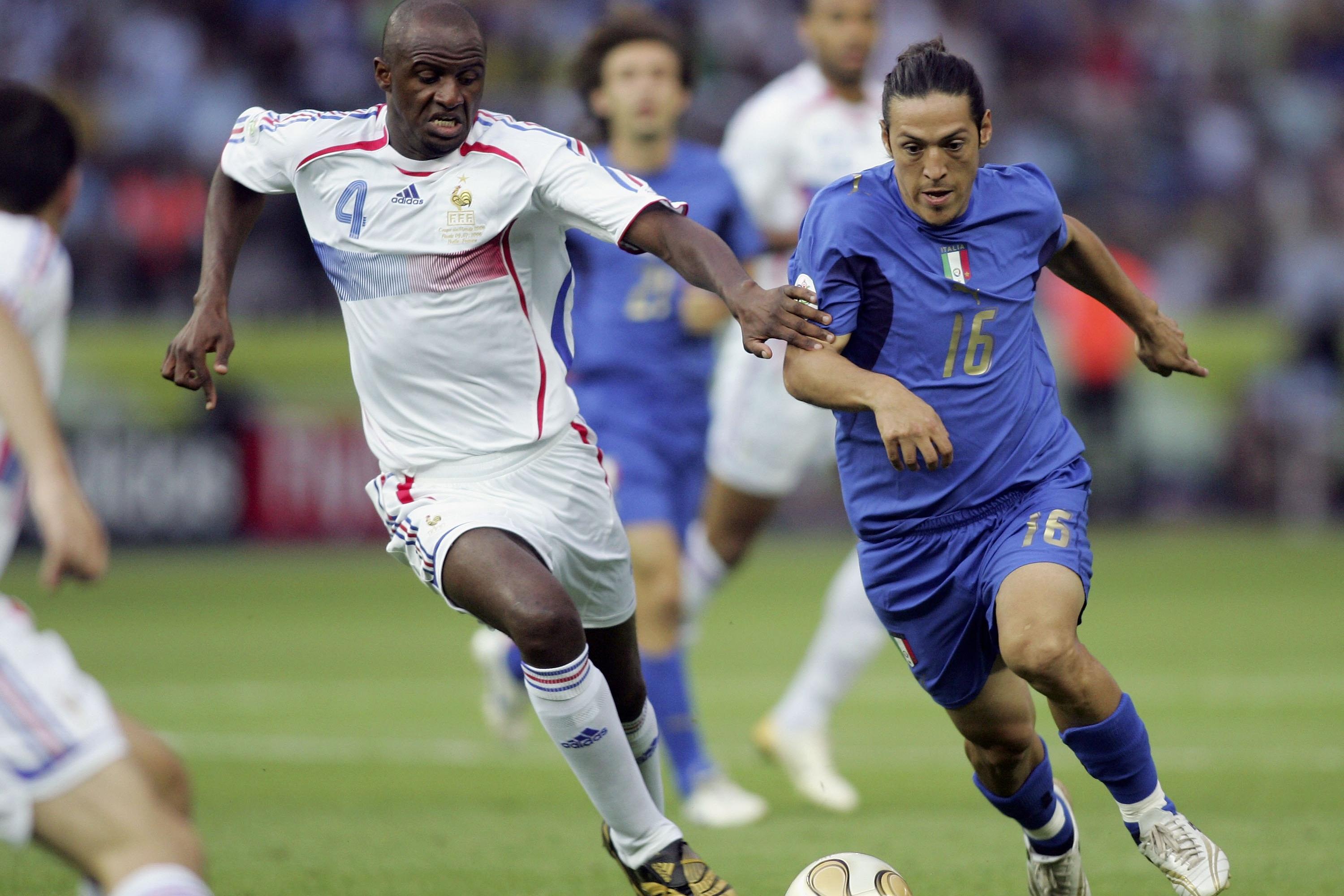 BERLIN - JULY 09:  Patrick Vieira (L) of France and Mauro Camoranesi of Italy battle for the ball during the FIFA World Cup Germany 2006 Final match between Italy and France at the Olympic Stadium on July 9, 2006 in Berlin, Germany.  (Photo by Ben Radford/Getty Images)